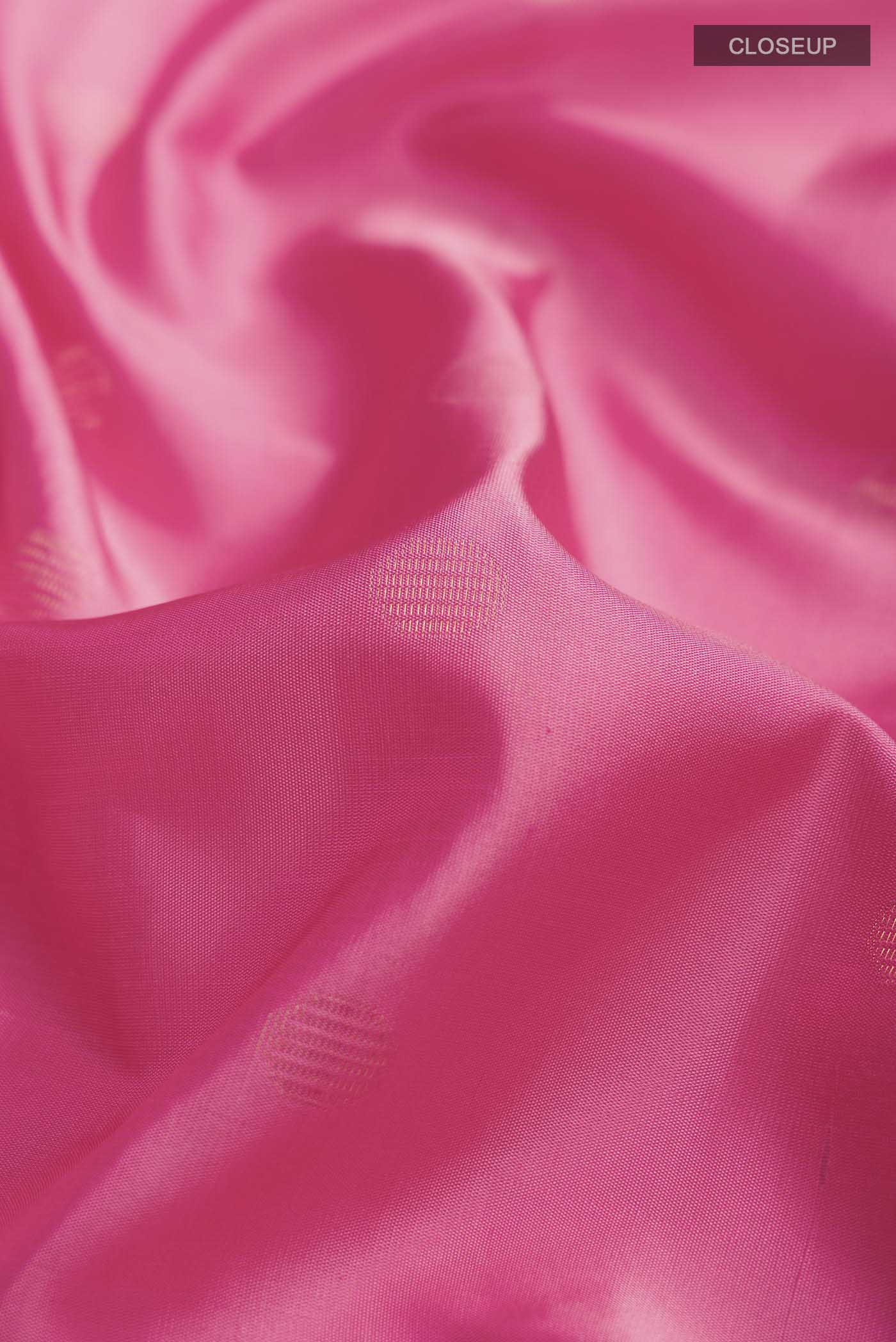 Close up of Pink Soft Silk Saree with Zari Butta on the body and Zari Border displaying folds