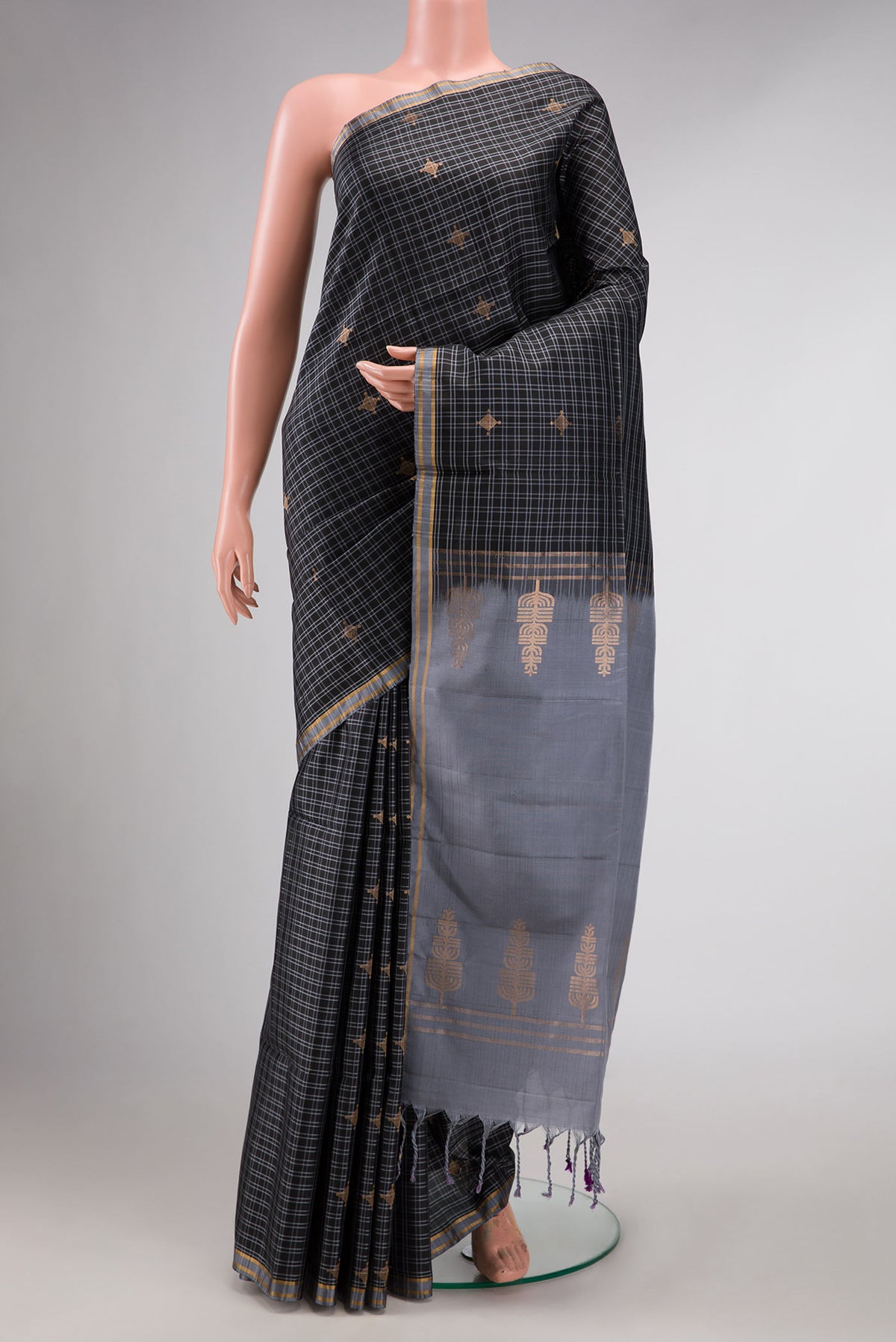 Black Dual Tone Soft Silk Saree with Checked design on the body and Zari Border displayed on a mannequin