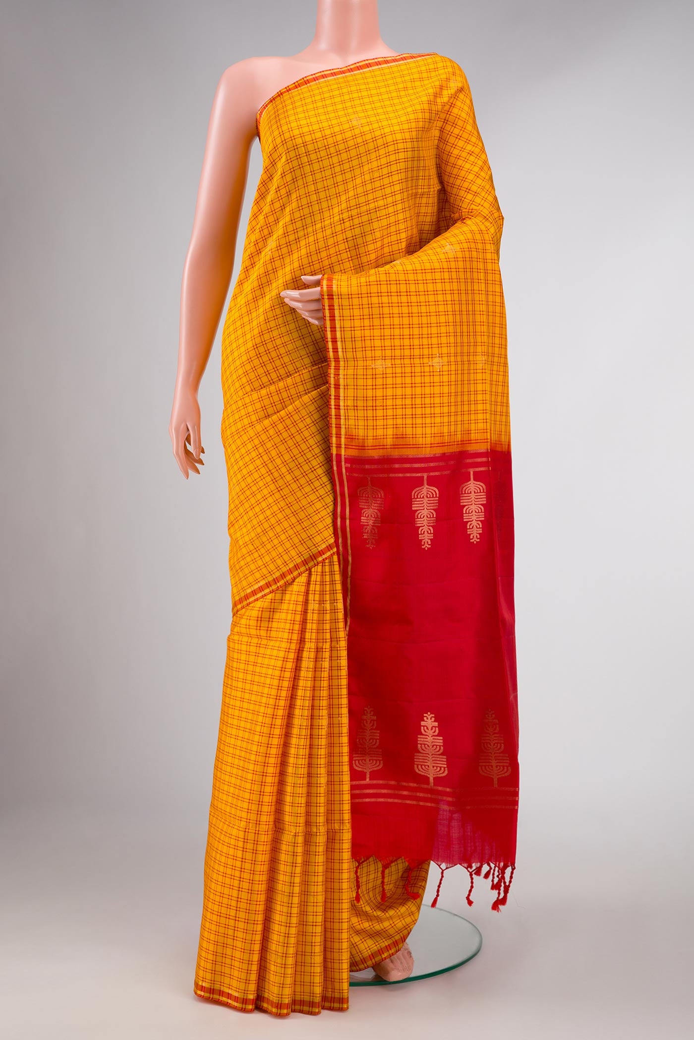 Yellow Soft Silk Saree with Checked design on the body and Thread Border displayed on a mannequin