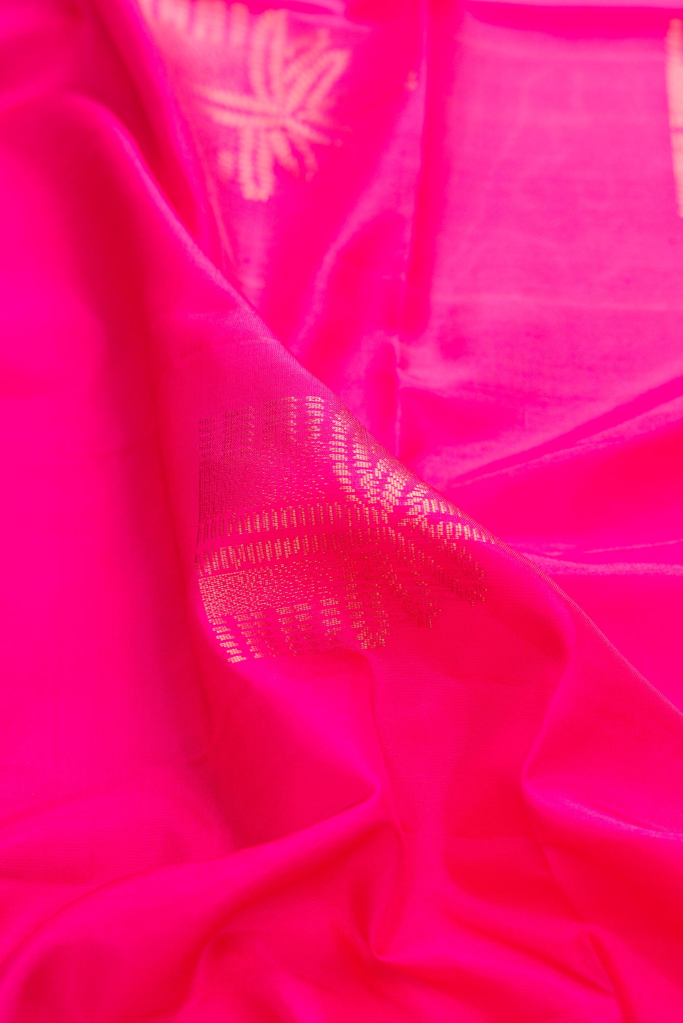 Close up of Pink Dual Tone Soft Silk Saree with Zari Butta on the body and Without Border displaying folds