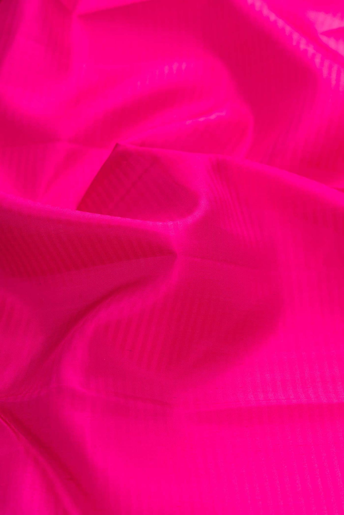 Close up of Pink Dual Tone Kanchipuram Silk Saree with Stripes on the body and Zari Border displaying folds