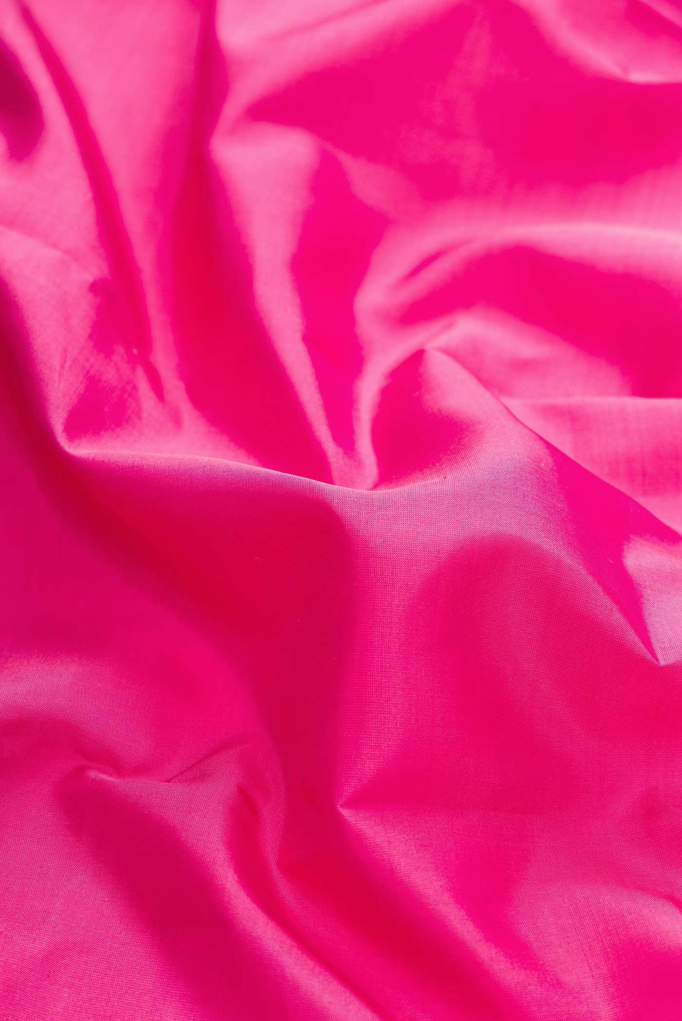 Close up of Pink Dual Tone Kanchipuram Silk Saree with Plain Body and Zari Border displaying folds