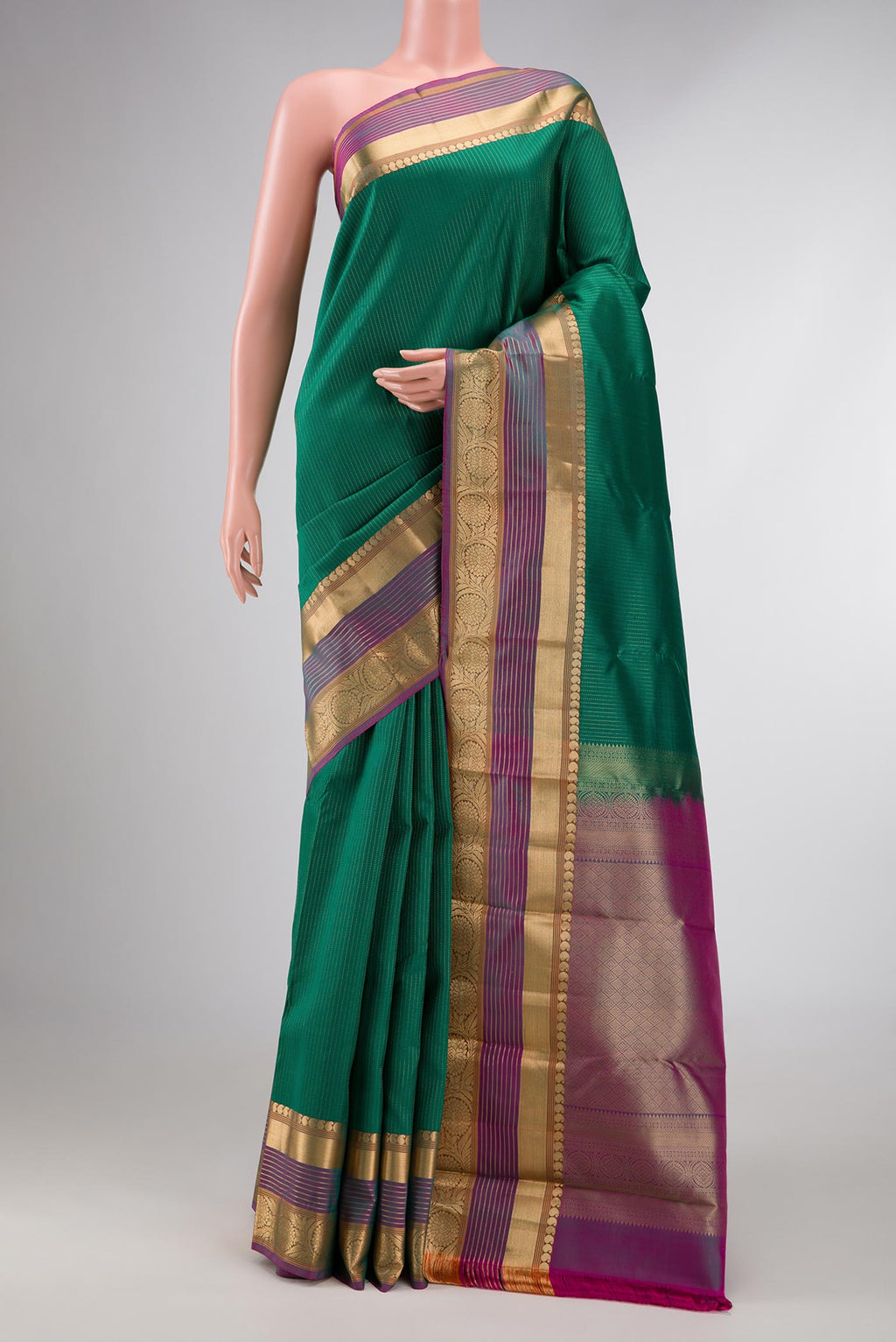 Green Dual Tone Kanchipuram Silk Saree with Stripes on the body and Zari Border displayed on a mannequin