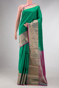 Green Dual Tone Kanchipuram Silk Saree with Zari Butta on the body and Zari Border displayed on a mannequin