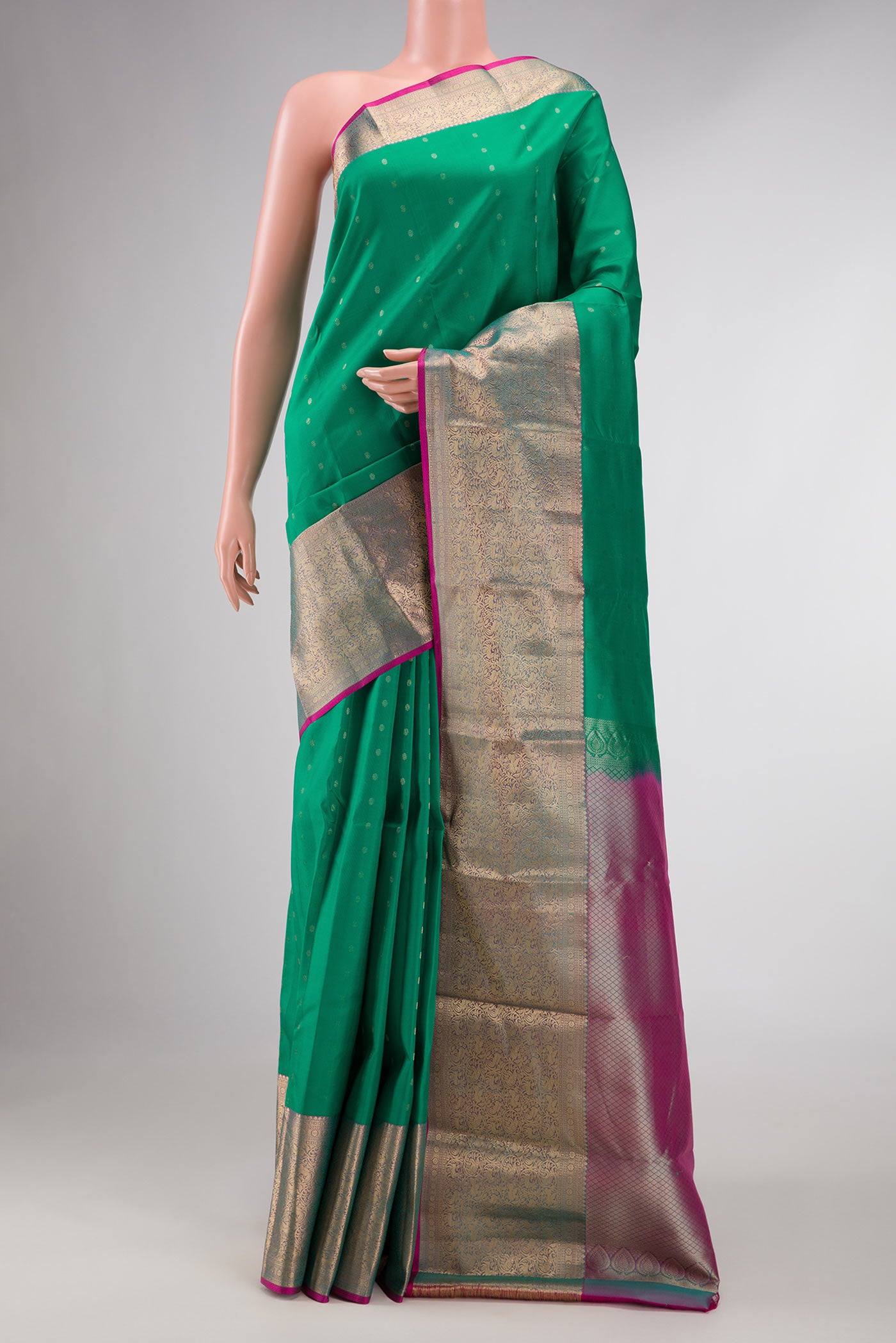 Green Dual Tone Kanchipuram Silk Saree with Zari Butta on the body and Zari Border displayed on a mannequin