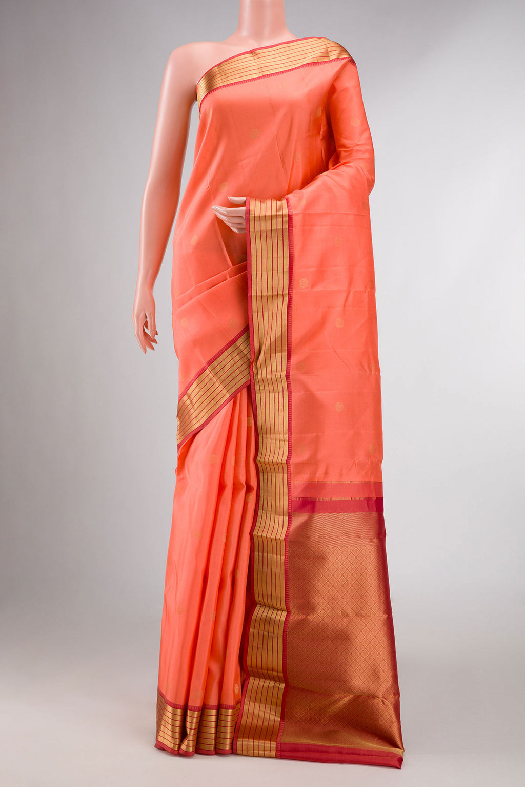 Orange Kanchipuram Silk Saree with Zari Butta on the body and Zari Border displayed on a mannequin
