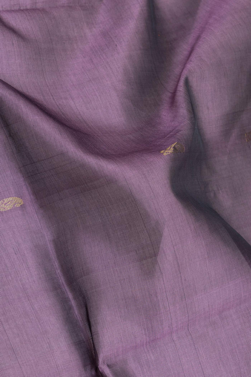 Close up of Purple Silk Cotton Saree with Zari Butta on the body and Zari Border.  displaying folds