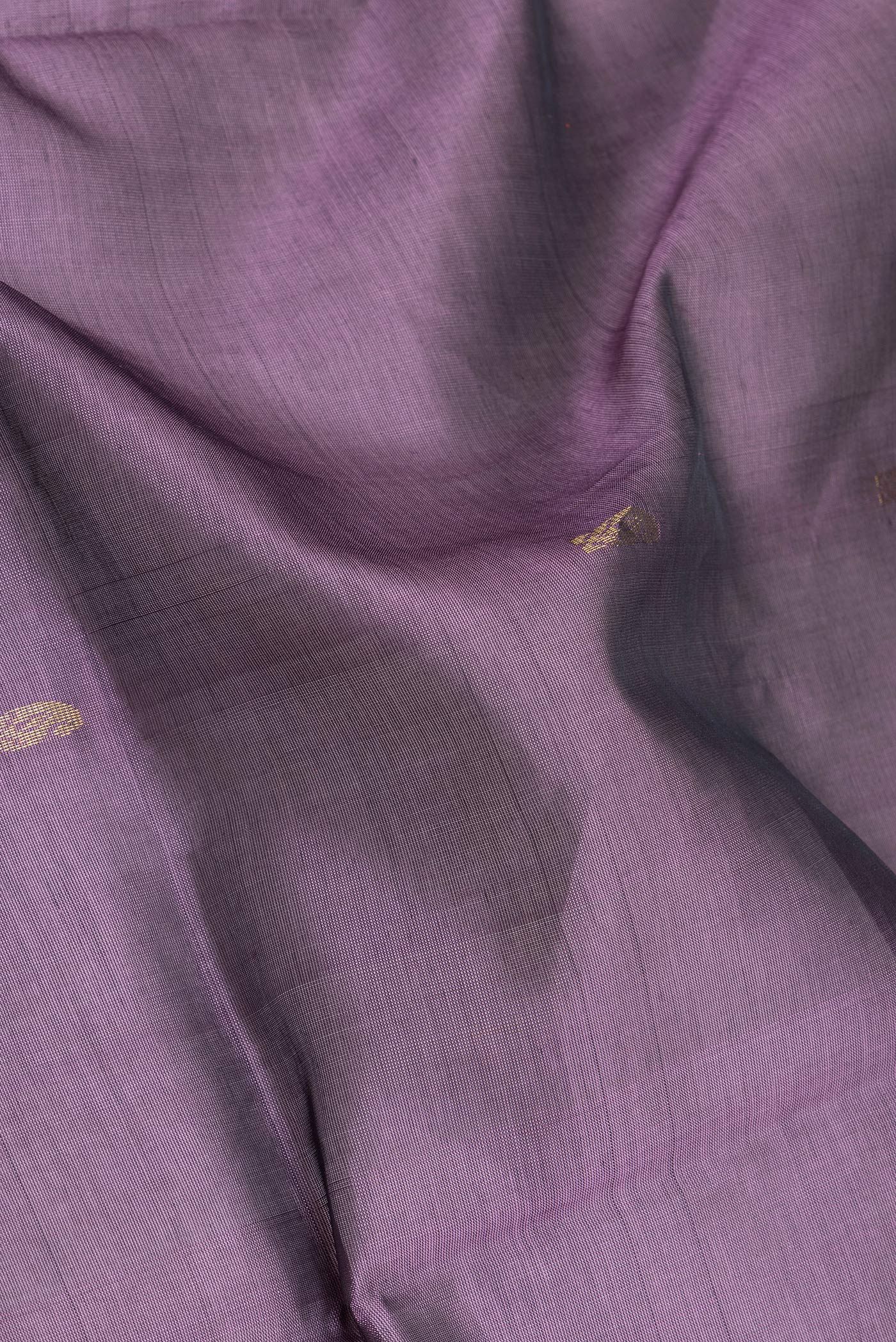 Close up of Purple Silk Cotton Saree with Zari Butta on the body and Zari Border.  displaying folds