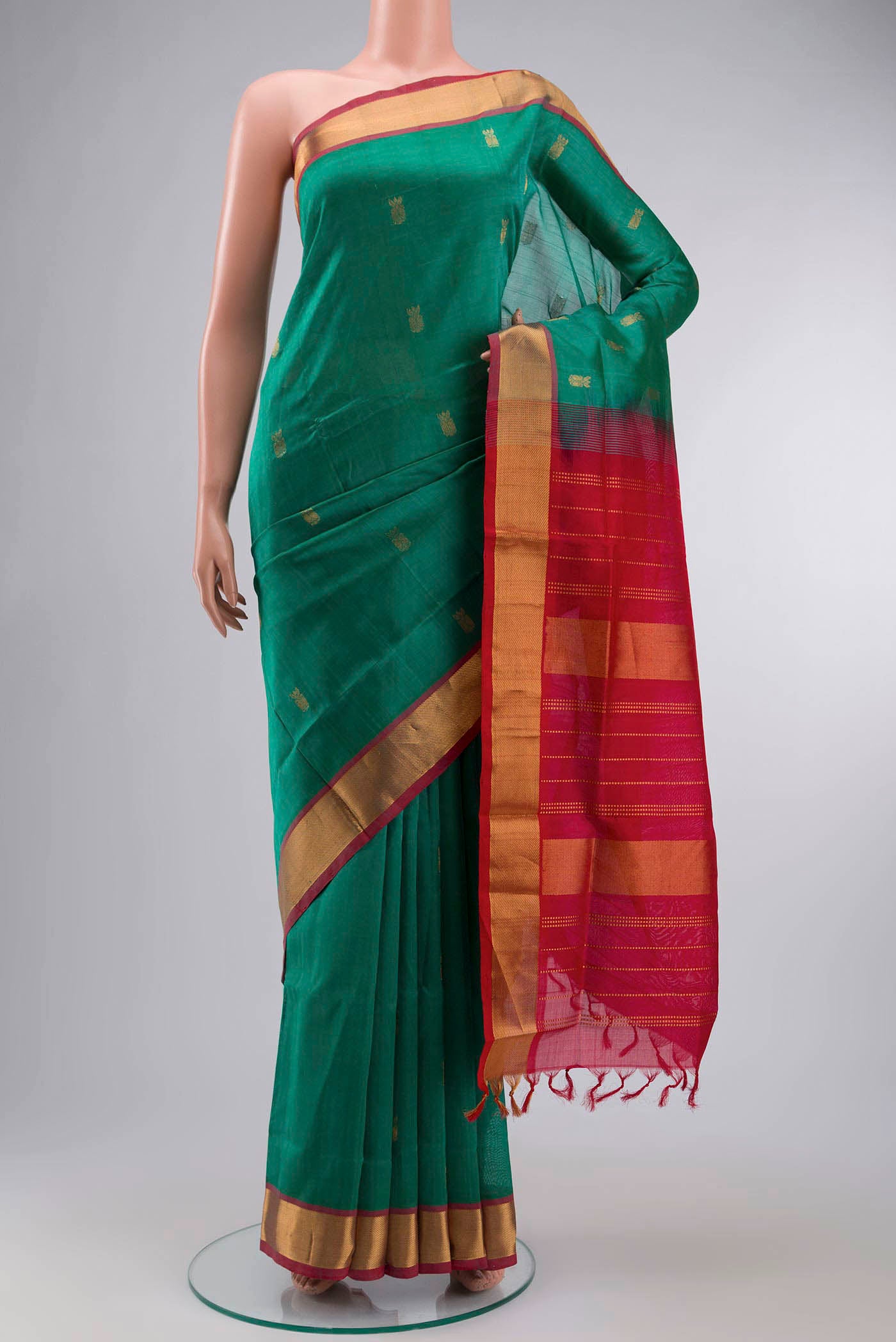 Green Silk Cotton Saree with Zari Butta on the body and Zari Border displayed on a mannequin