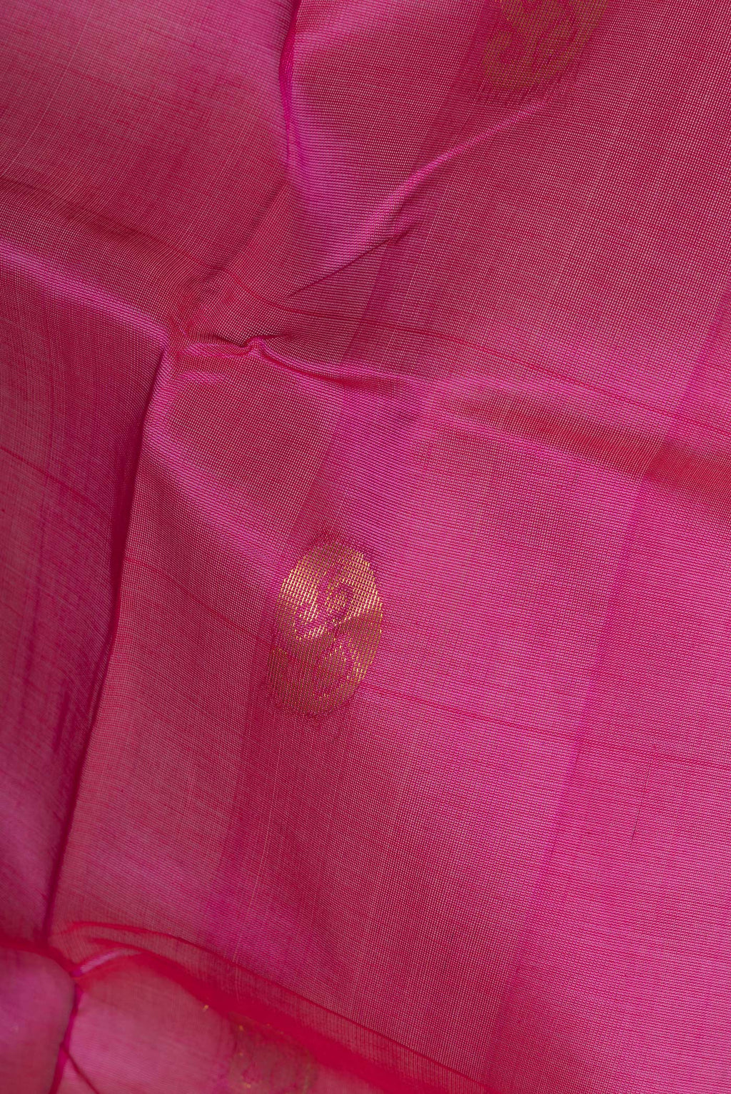 Close up of Pink Silk Cotton Saree with Zari Butta on the body and Zari Border.  displaying folds