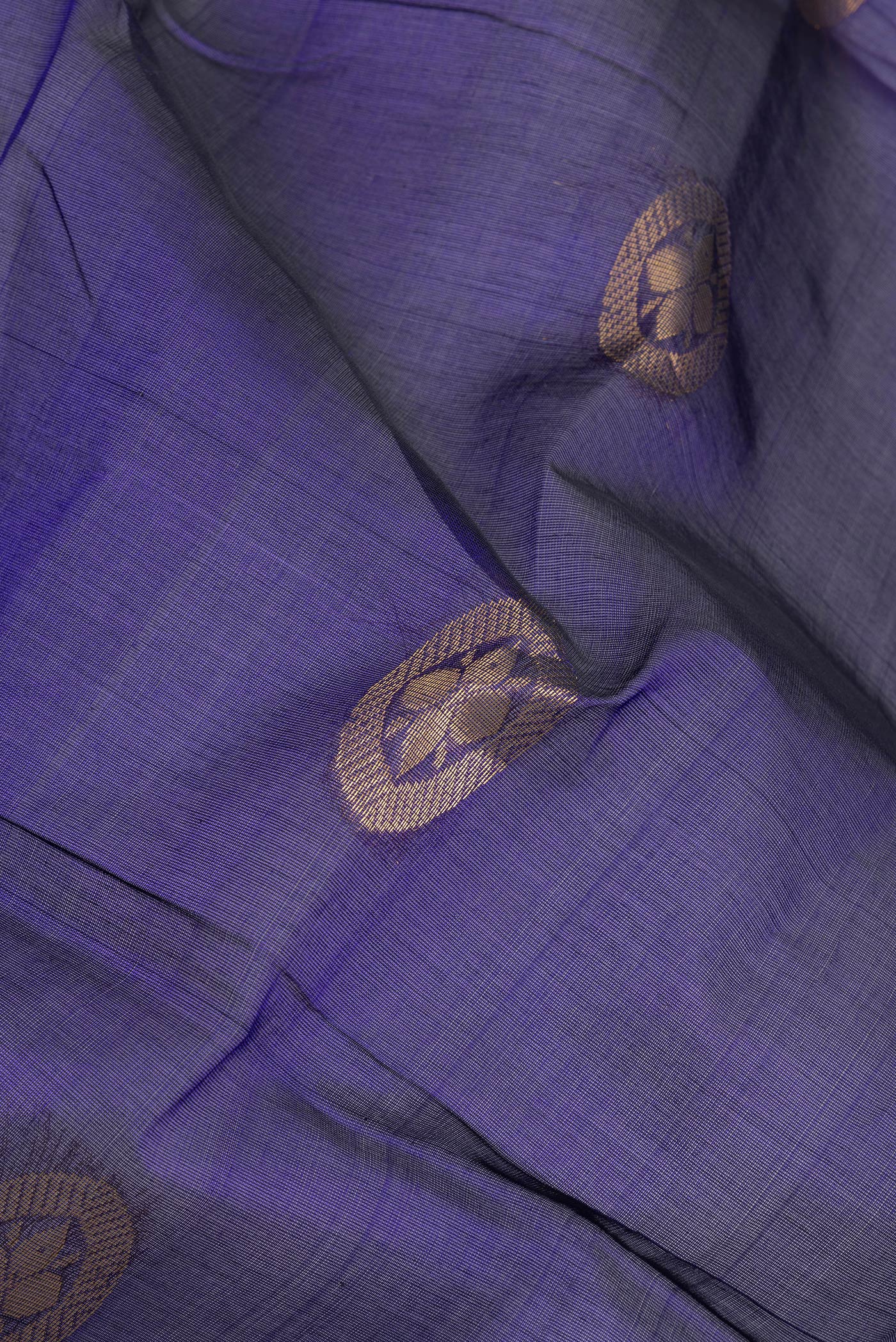 Close up of Dark Blue Silk Cotton Saree with Zari Butta on the body and Zari Border.  displaying folds