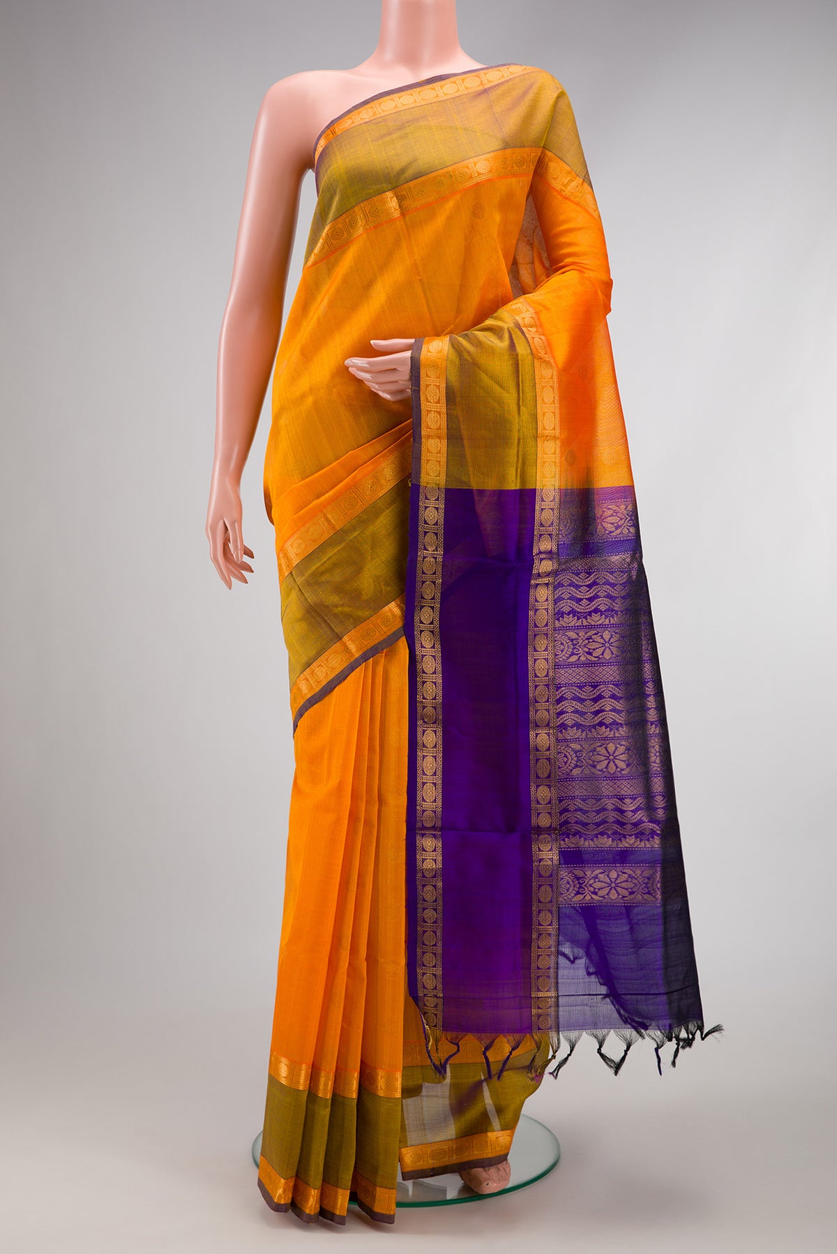Orange Silk Cotton Saree with Zari Butta on the body and Zari Border.  displayed on a mannequin
