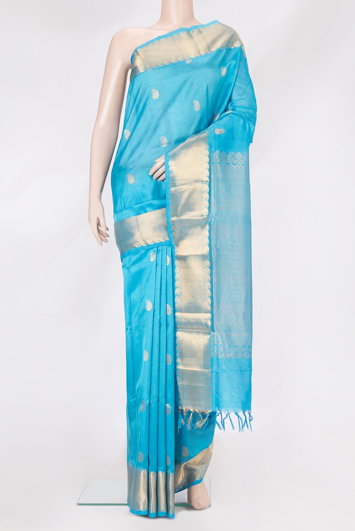 Sky Blue Silk Cotton Saree with Zari Butta on the body and Zari Border.  displayed on a mannequin
