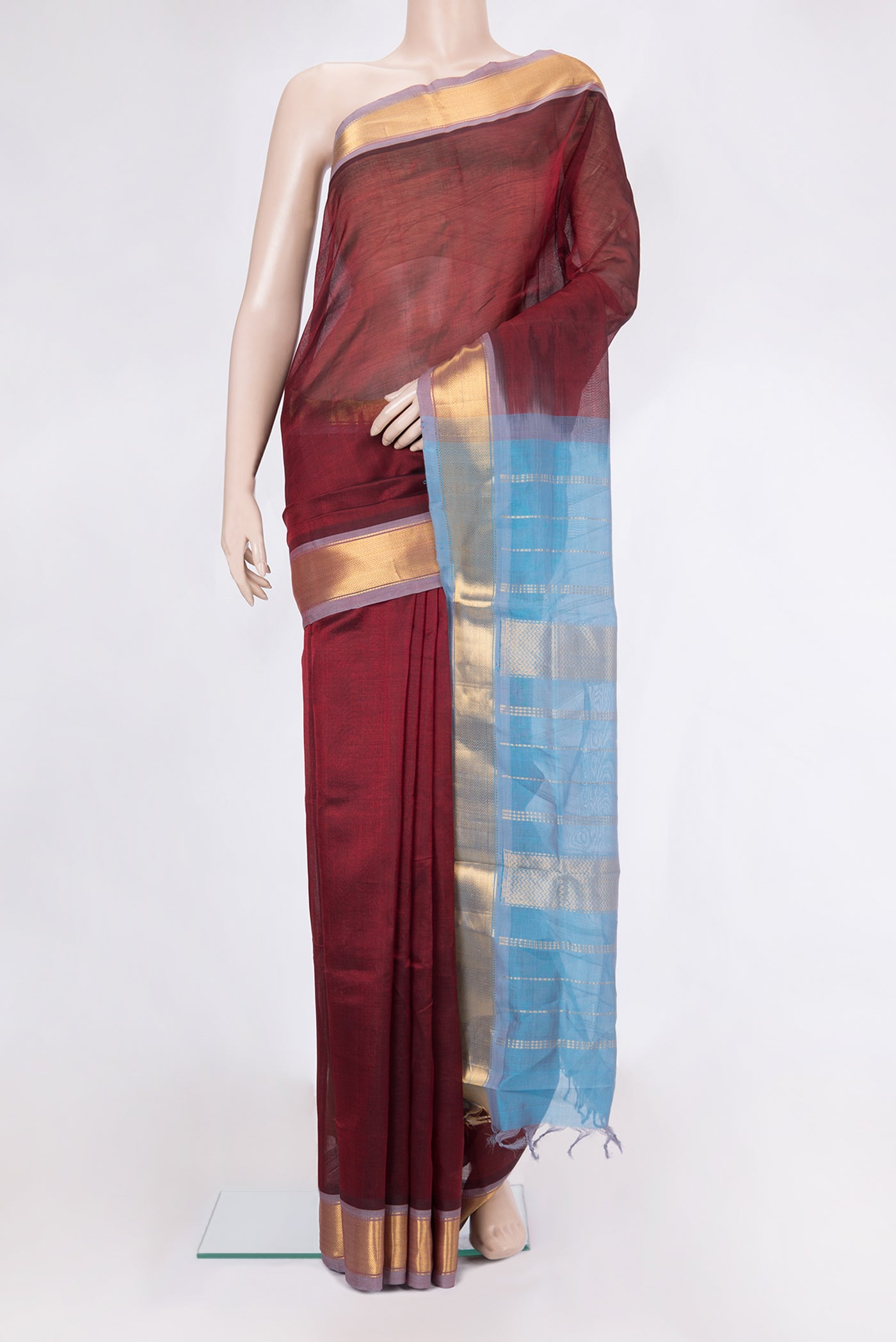Maroon Silk Cotton Saree with Plain Body and Zari Border.  displayed on a mannequin