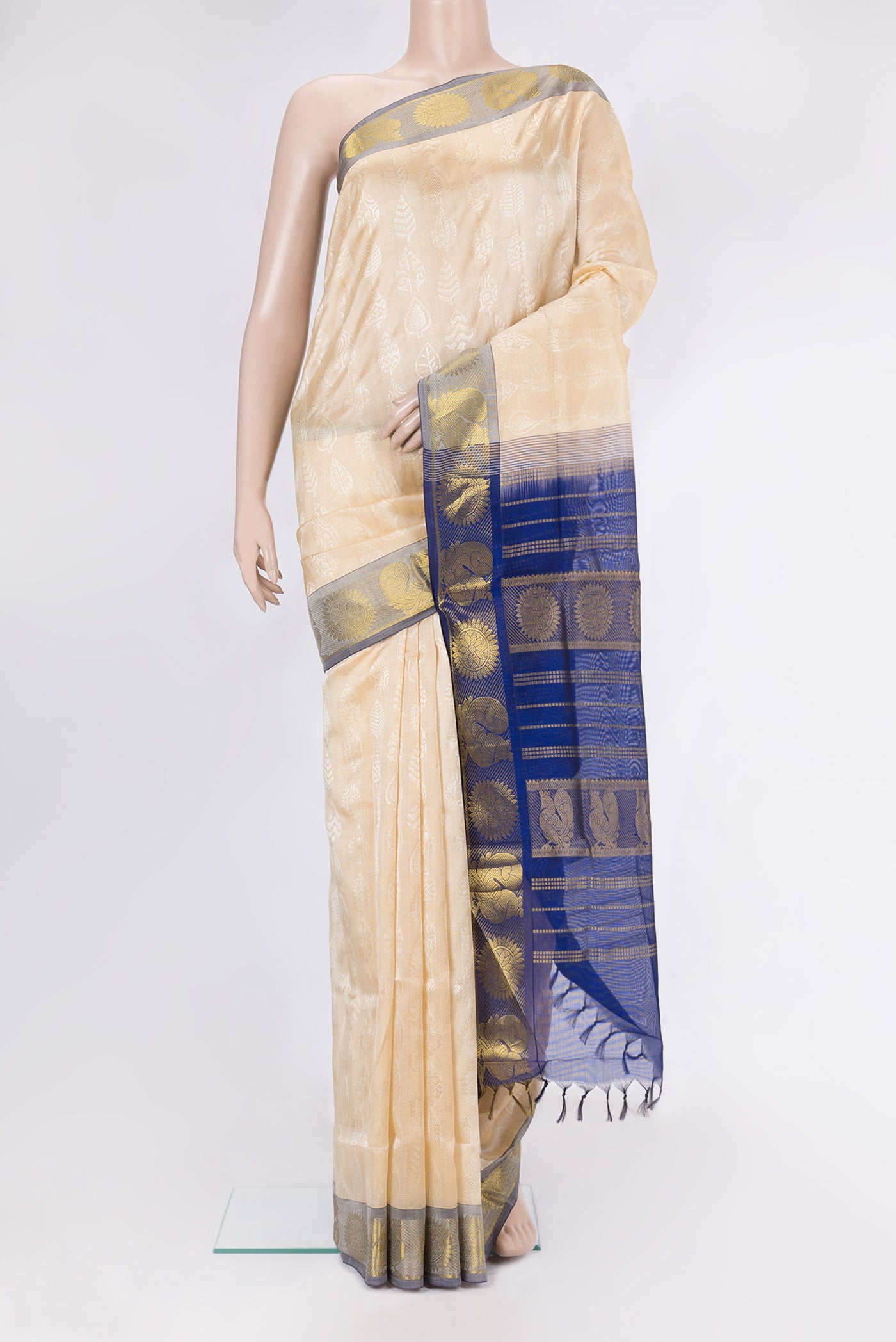 Beige Silk Cotton Saree with Jacquard design on the body and Zari Border.  displayed on a mannequin