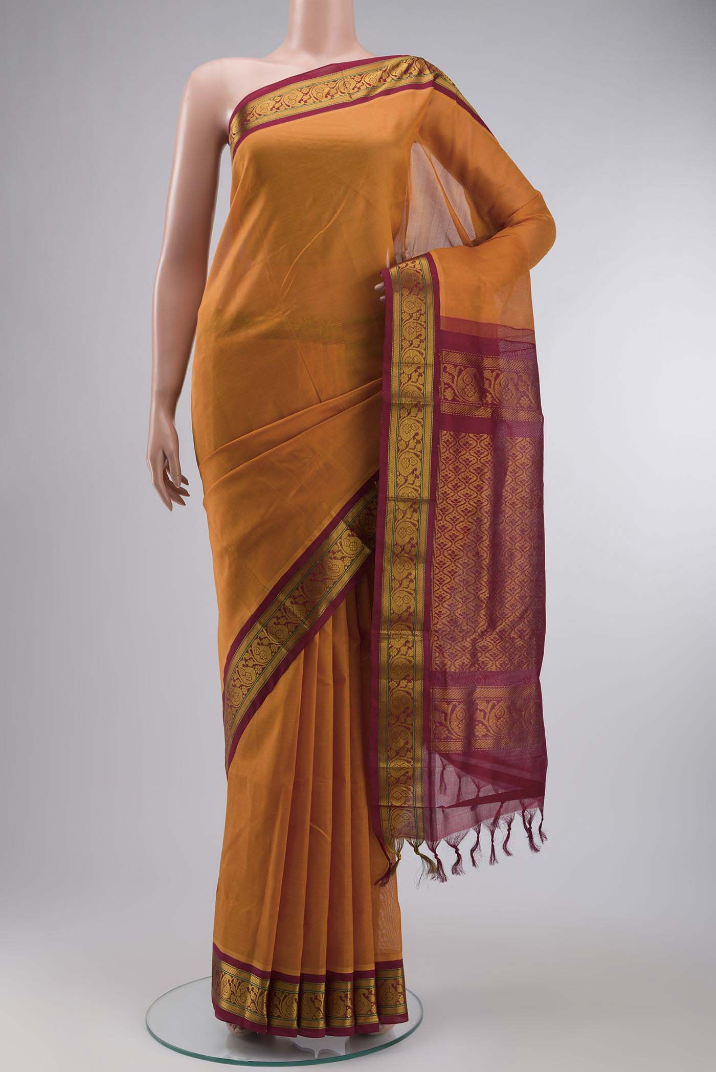 Orange Silk Cotton Saree with Plain Body and Zari Border displayed on a mannequin