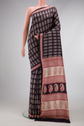 Black Printed Silk Saree with Printed design on the body and Printed Border.  displayed on a mannequin