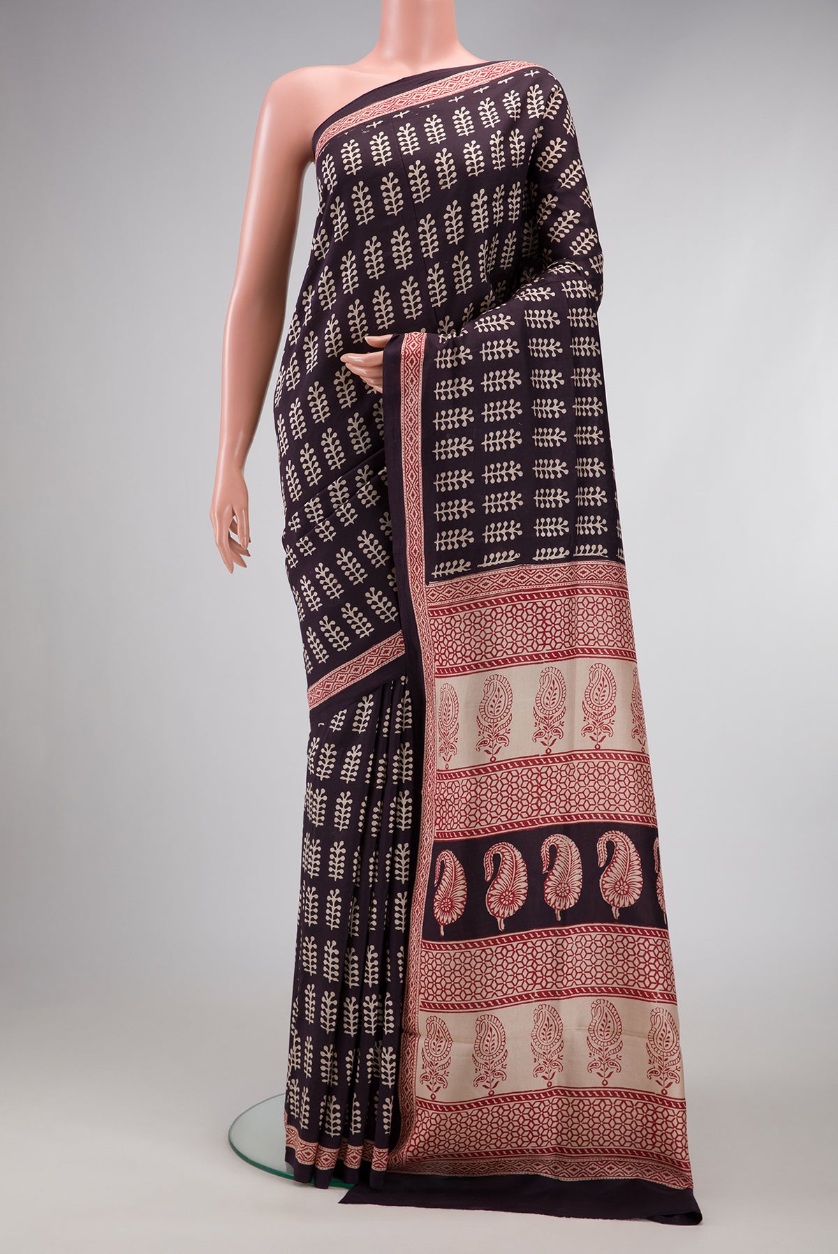 Black Printed Silk Saree with Printed design on the body and Printed Border.  displayed on a mannequin
