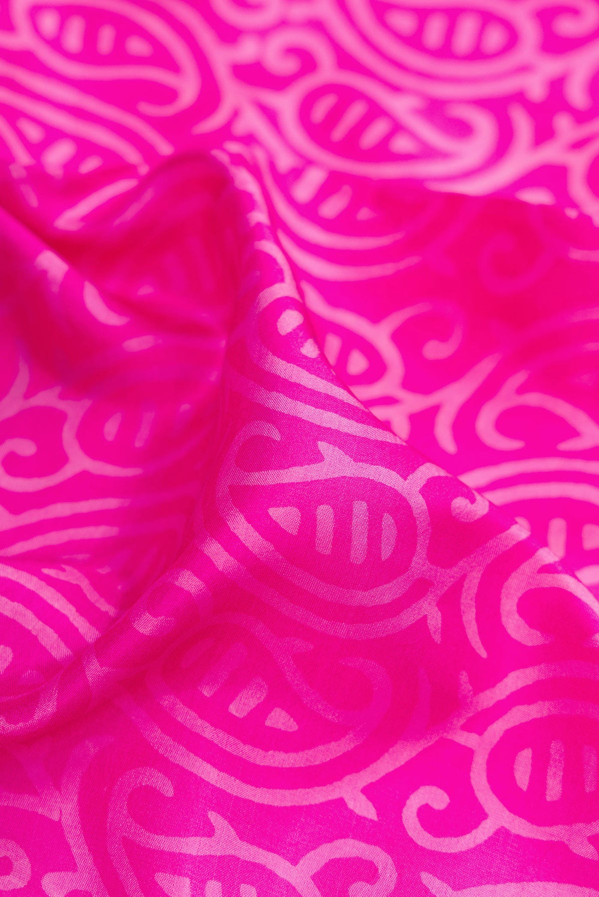 Close up of Pink Printed Silk Saree with Printed design on the body and Printed Border.  displaying folds