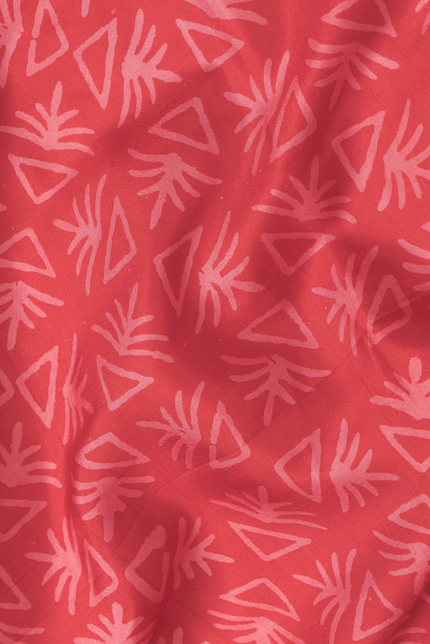Close up of Red Dual Tone Printed Silk Saree with Printed design on the body and Printed Border.  displaying folds