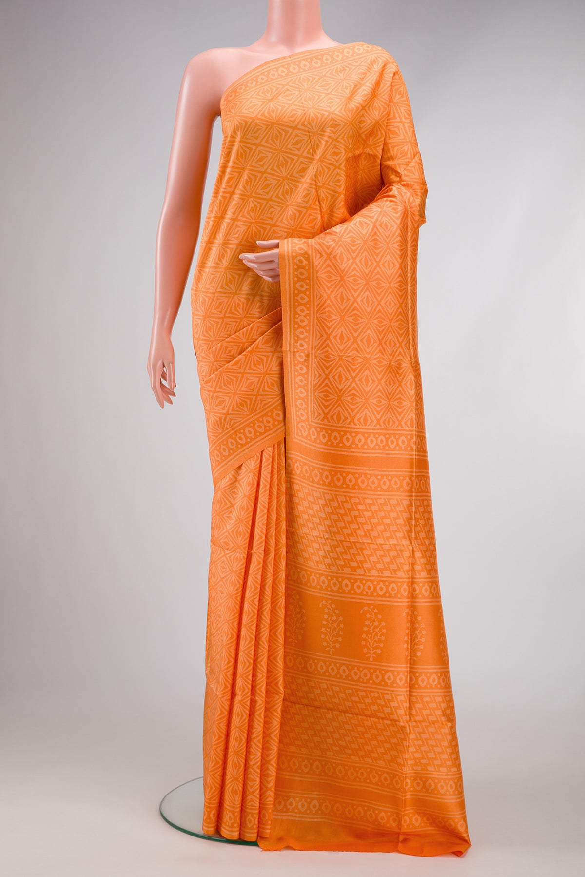 Orange Dual Tone Printed Silk Saree with Printed design on the body and Printed Border.  displayed on a mannequin