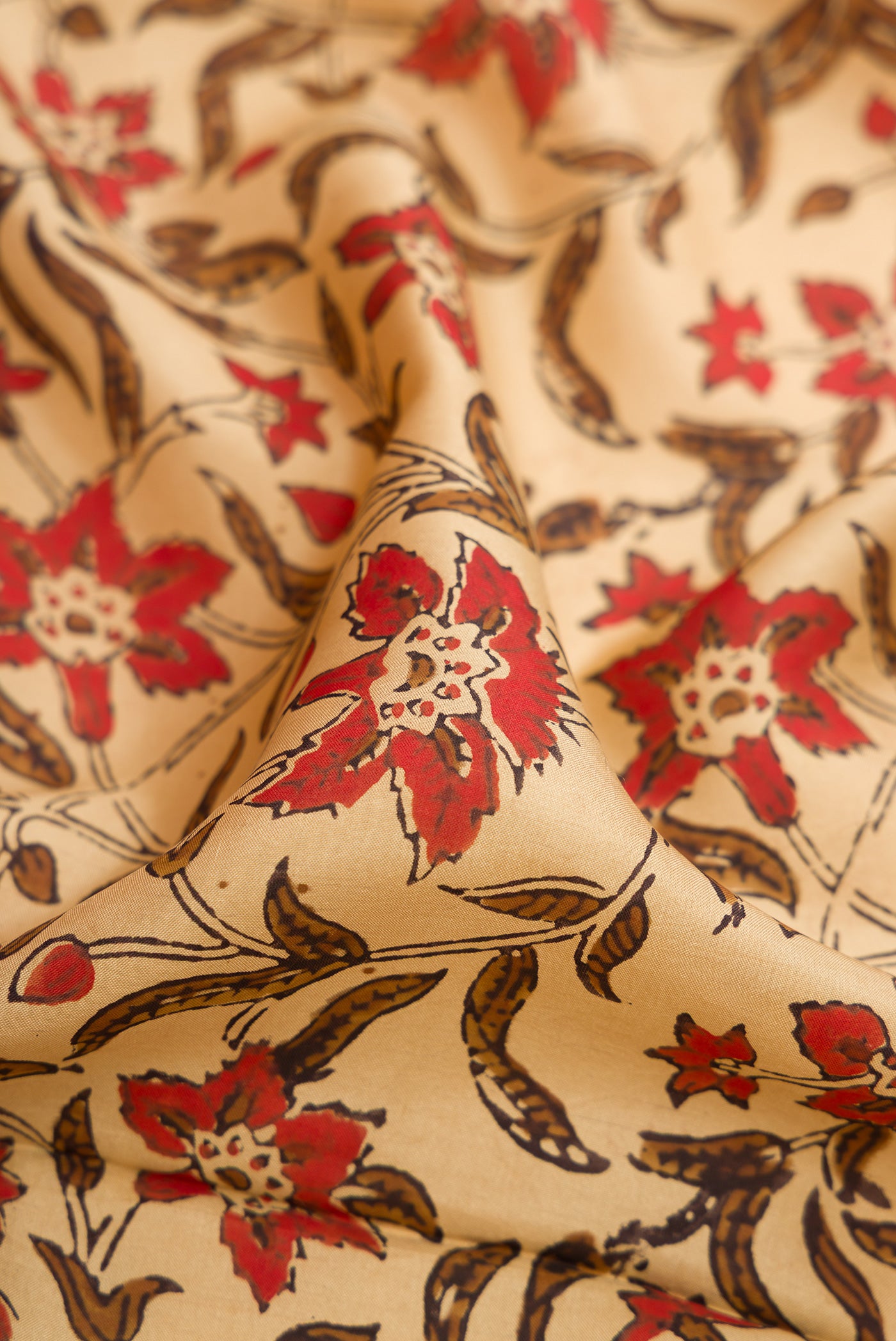 Close up of Beige Printed Silk Saree with Printed design on the body and Printed Border.  displaying folds