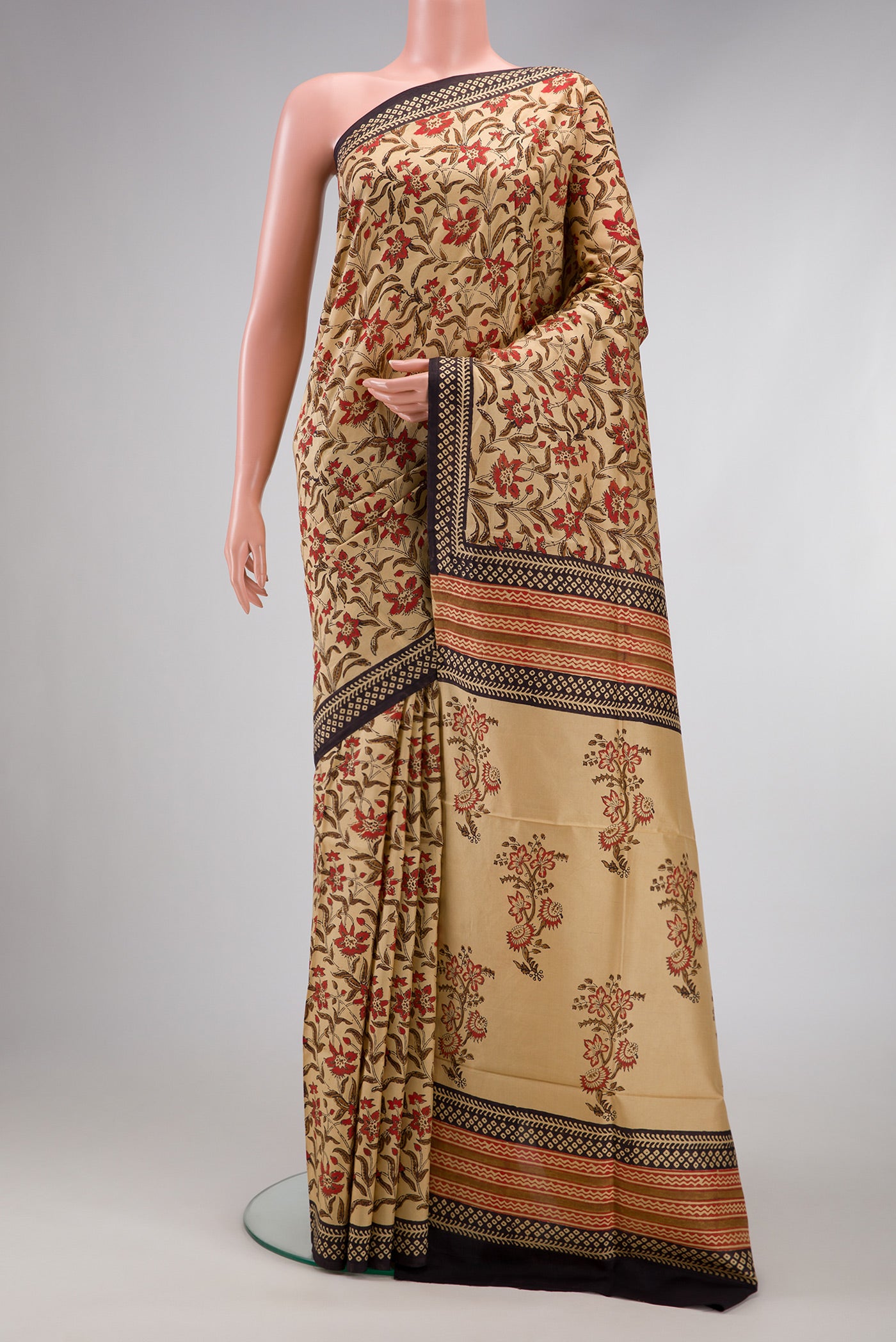 Beige Printed Silk Saree with Printed design on the body and Printed Border.  displayed on a mannequin