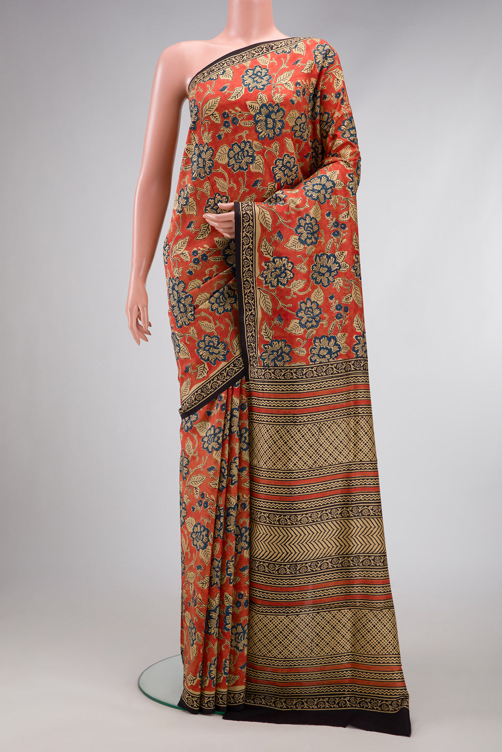 Orange Printed Silk Saree with Printed design on the body and Printed Border.  displayed on a mannequin