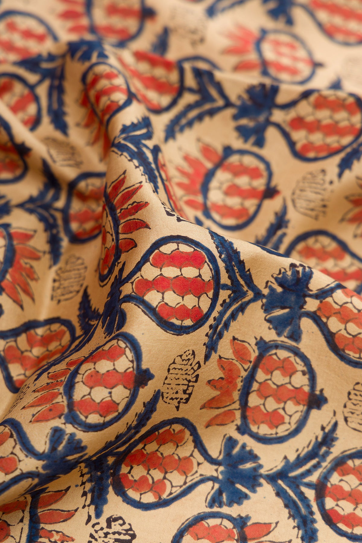 Close up of Beige Printed Silk Saree with Printed design on the body and Printed Border.  displaying folds