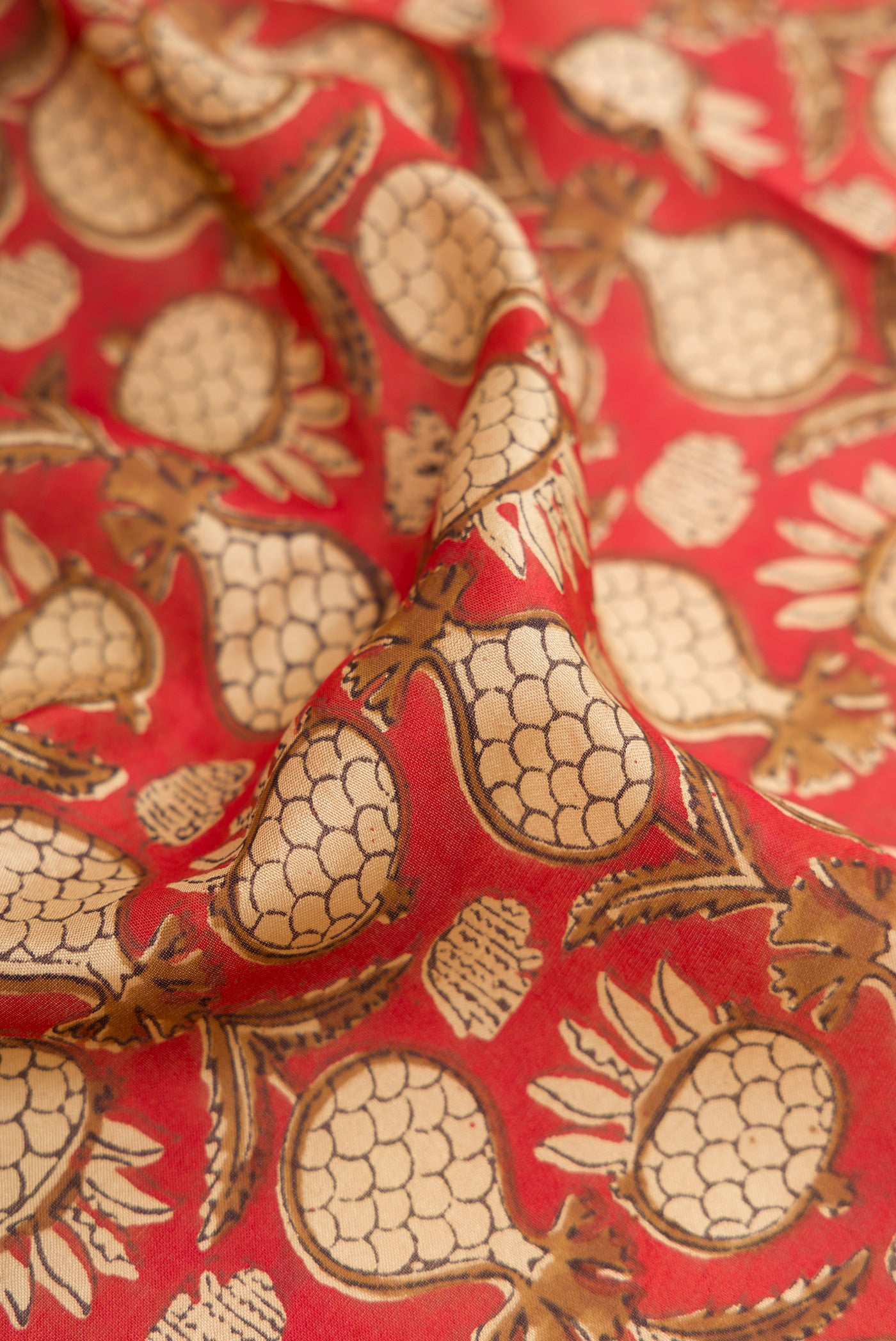 Close up of Rust Printed Silk Saree with Printed design on the body and Printed Border.  displaying folds