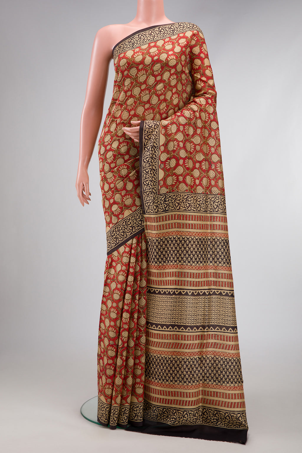 Rust Printed Silk Saree with Printed design on the body and Printed Border.  displayed on a mannequin