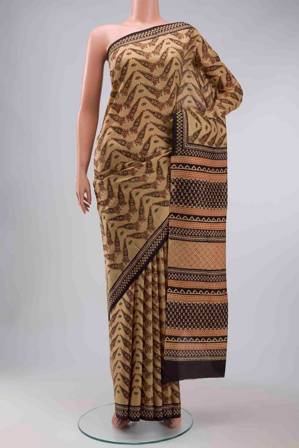Beige Printed Silk Saree with Printed design on the body and Printed Border displayed on a mannequin