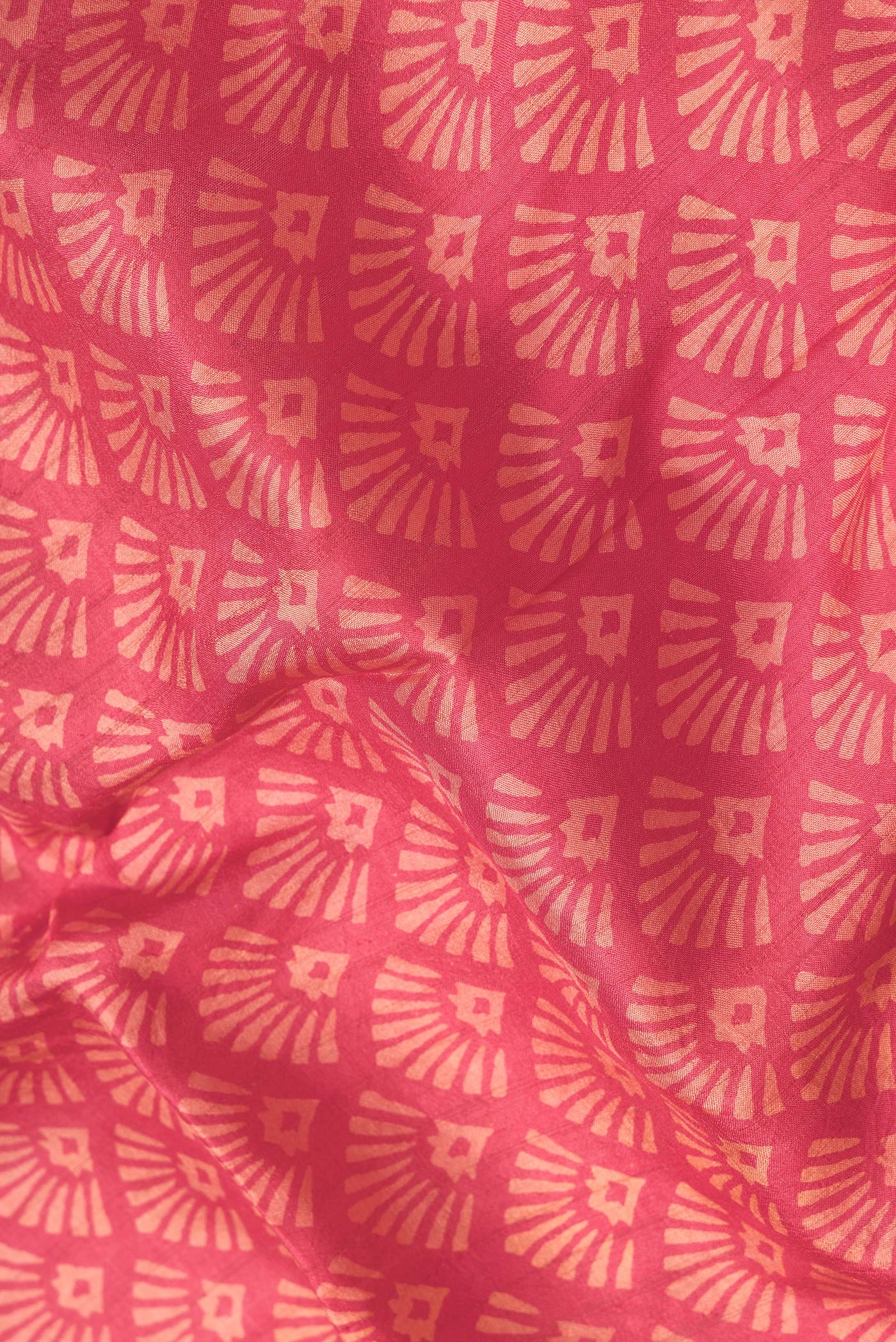 Close up of Red Dual Tone Printed Silk Saree with Printed design on the body and Zari Border.  displaying folds