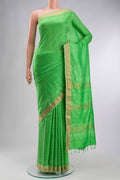 Green Printed Silk Saree with Printed design on the body and Zari Border displayed on a mannequin