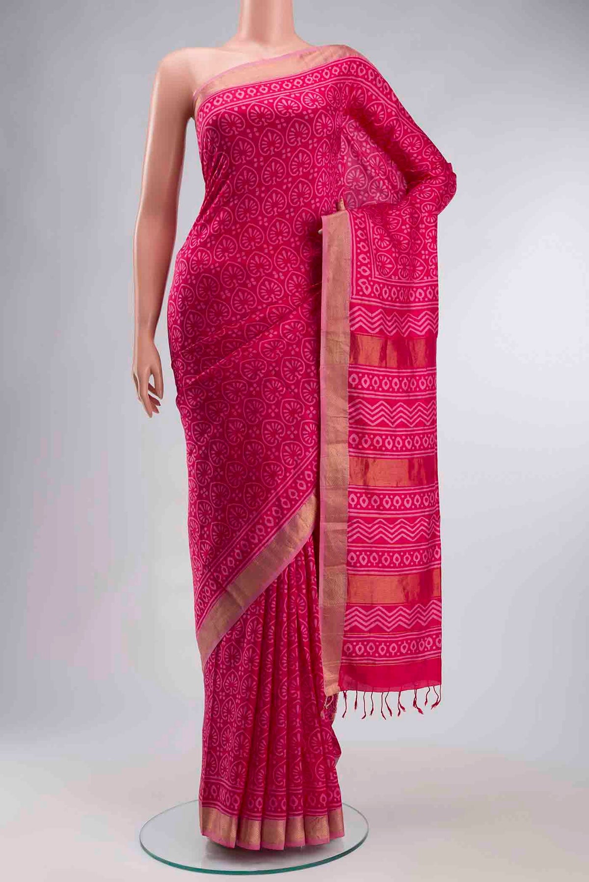Pink Printed Silk Saree with Printed design on the body and Zari Border displayed on a mannequin