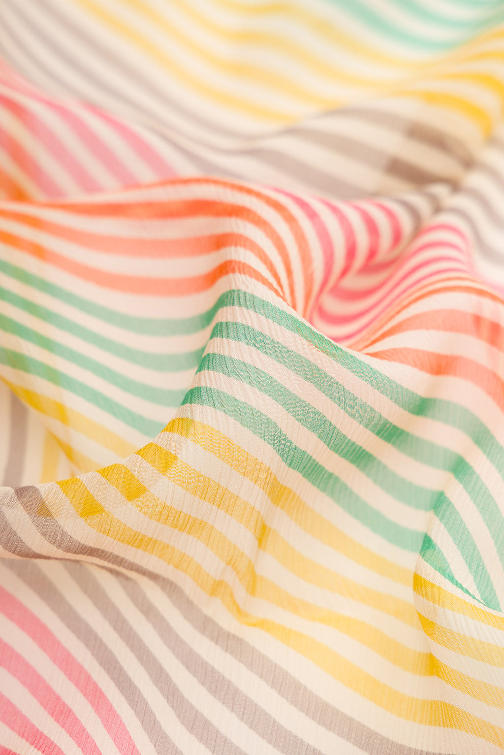 Close up of Multi Color Mysore Chiffon Saree with Printed design on the body and Thread Border.  displaying folds