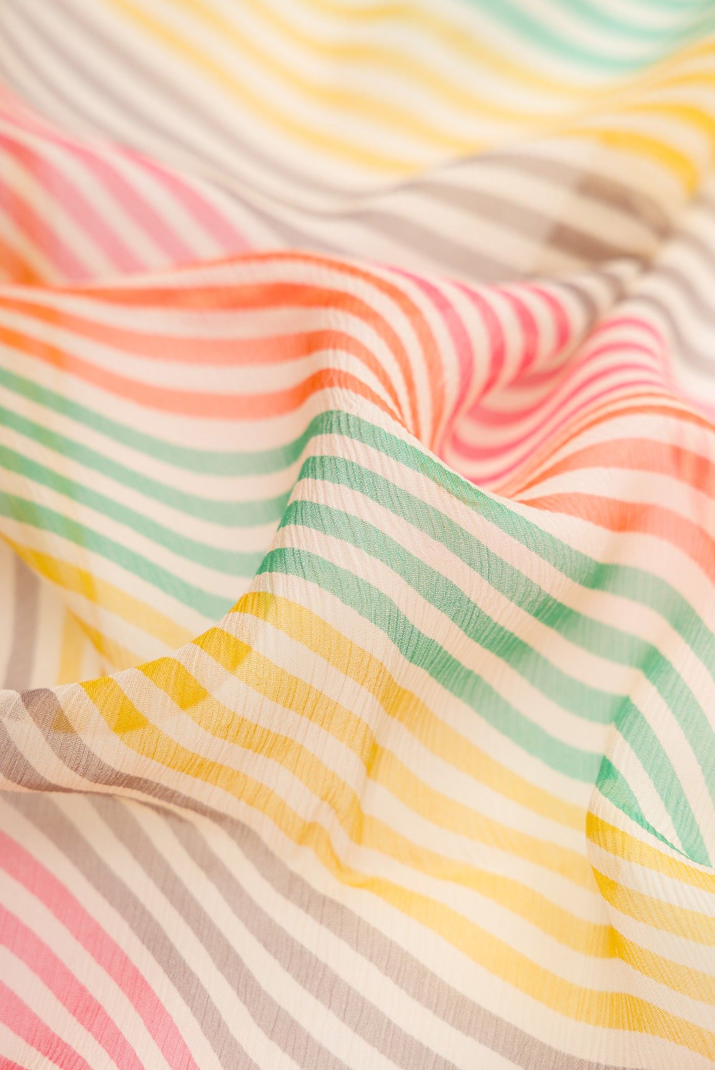 Close up of Multi Color Mysore Chiffon Saree with Printed design on the body and Thread Border.  displaying folds