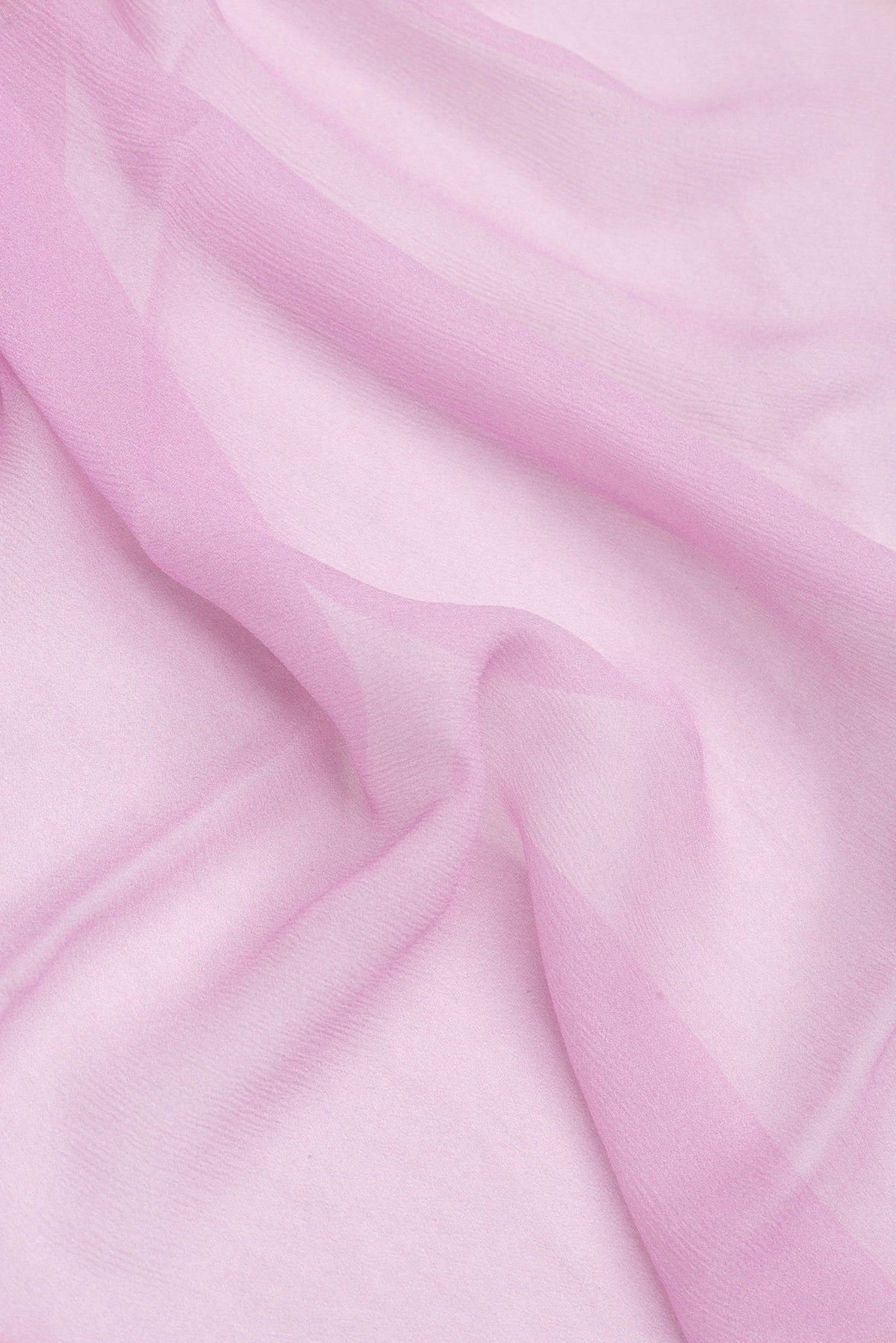 Close up of Pink Dual Tone Mysore Chiffon Saree with Printed design on the body and Printed Border.  displaying folds