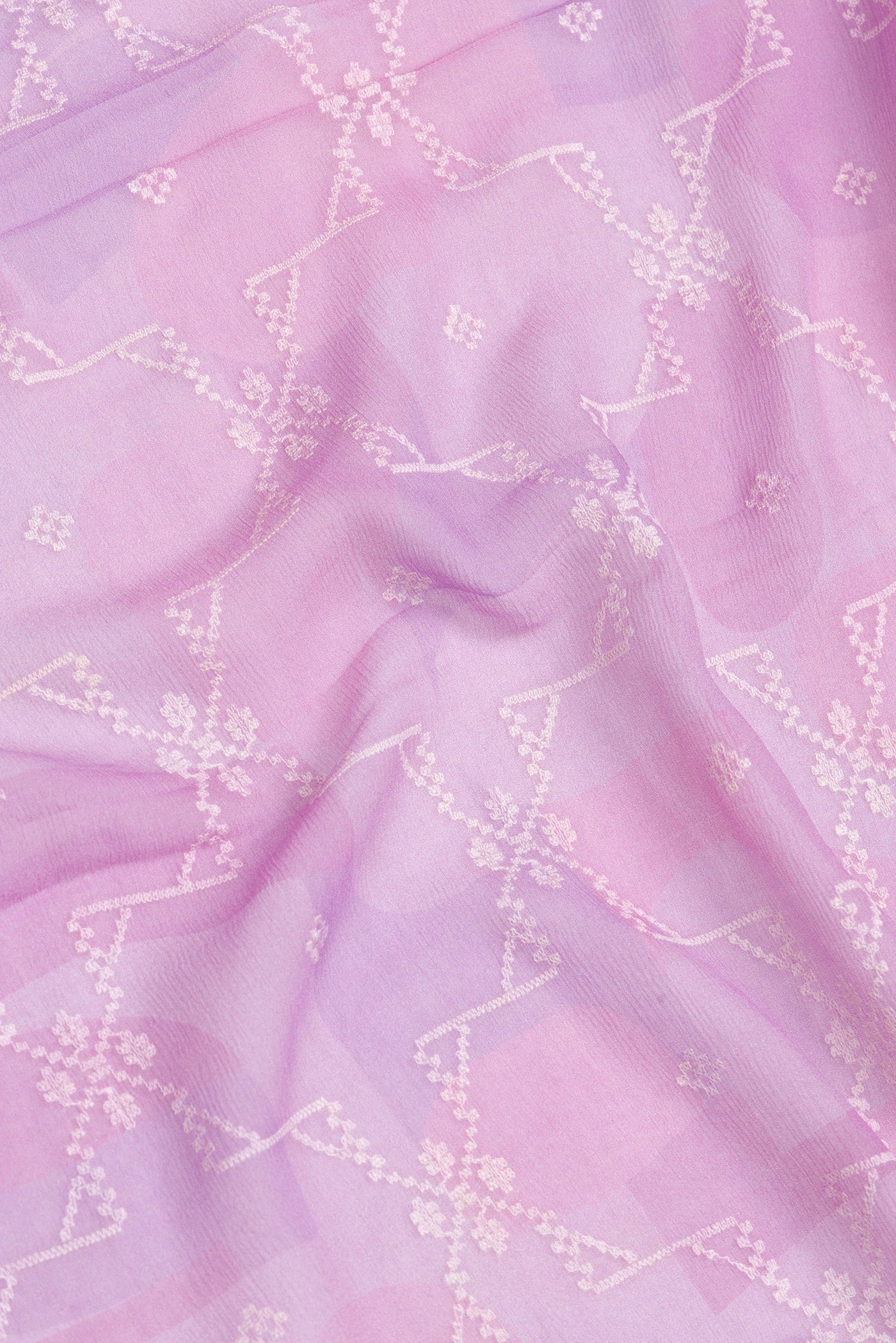 Close up of Lavender Dual Tone Chiffon Saree with Embroidery on the body and Zari Border.  displaying folds