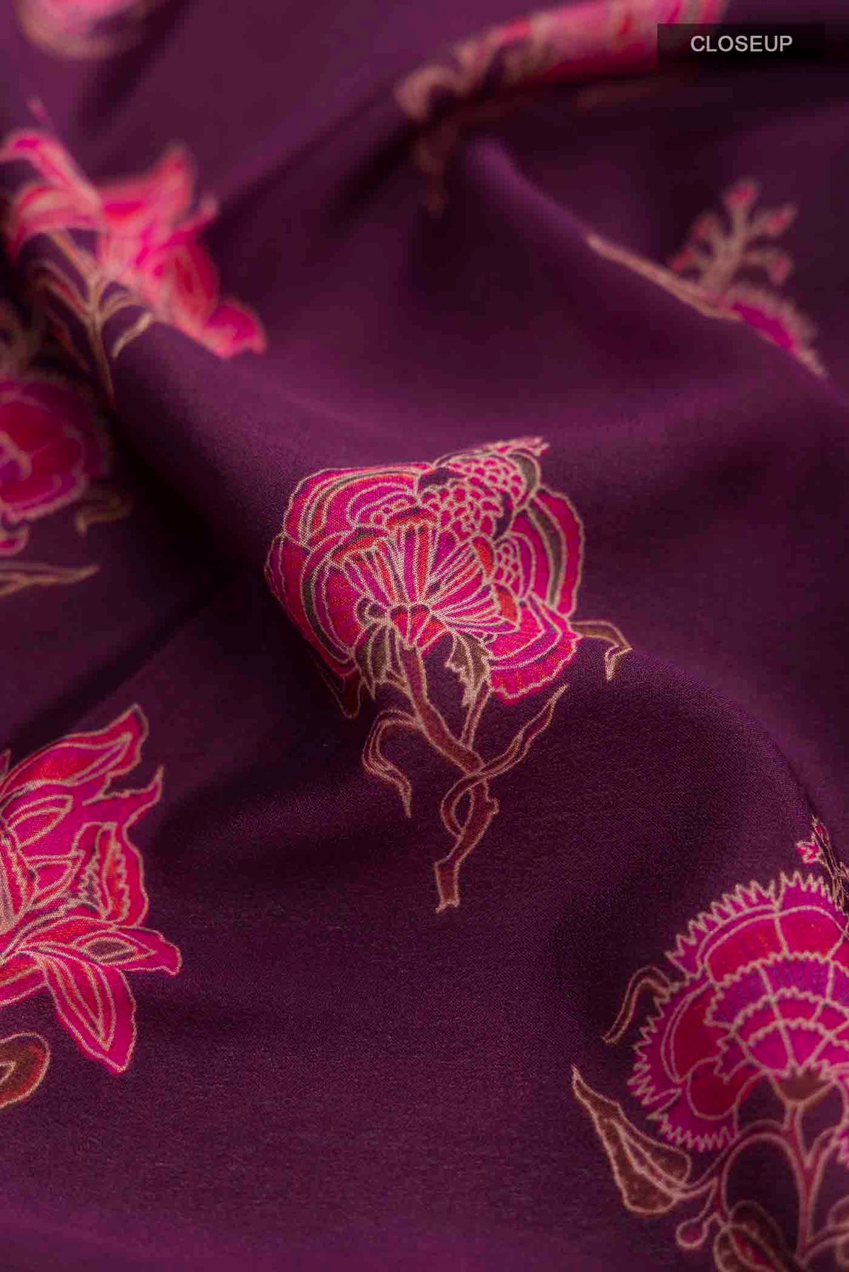 Close up of Purple Mysore Crepe Saree with Printed design on the body and Zari Border displaying folds