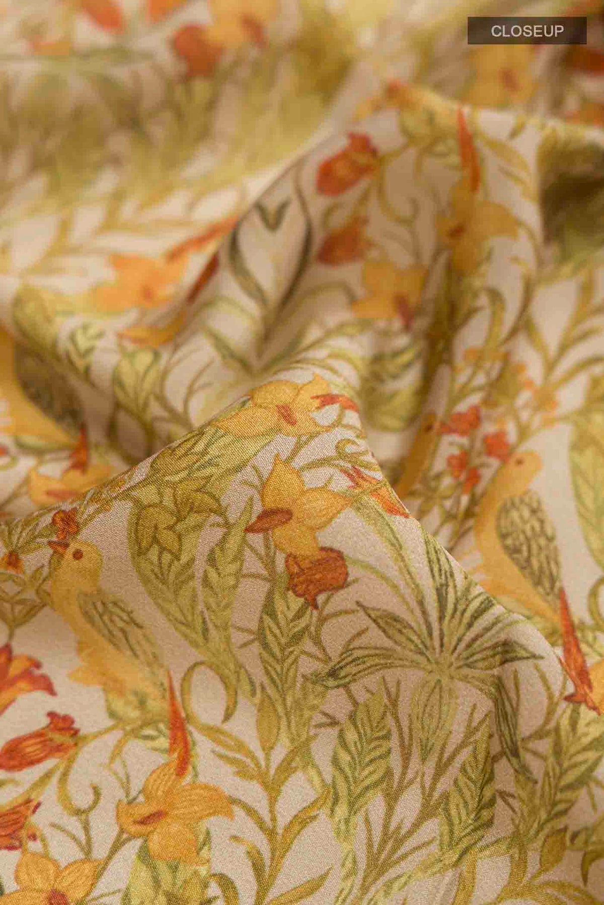 Close up of Green Mysore Crepe Saree with Printed design on the body and Zari Border displaying folds