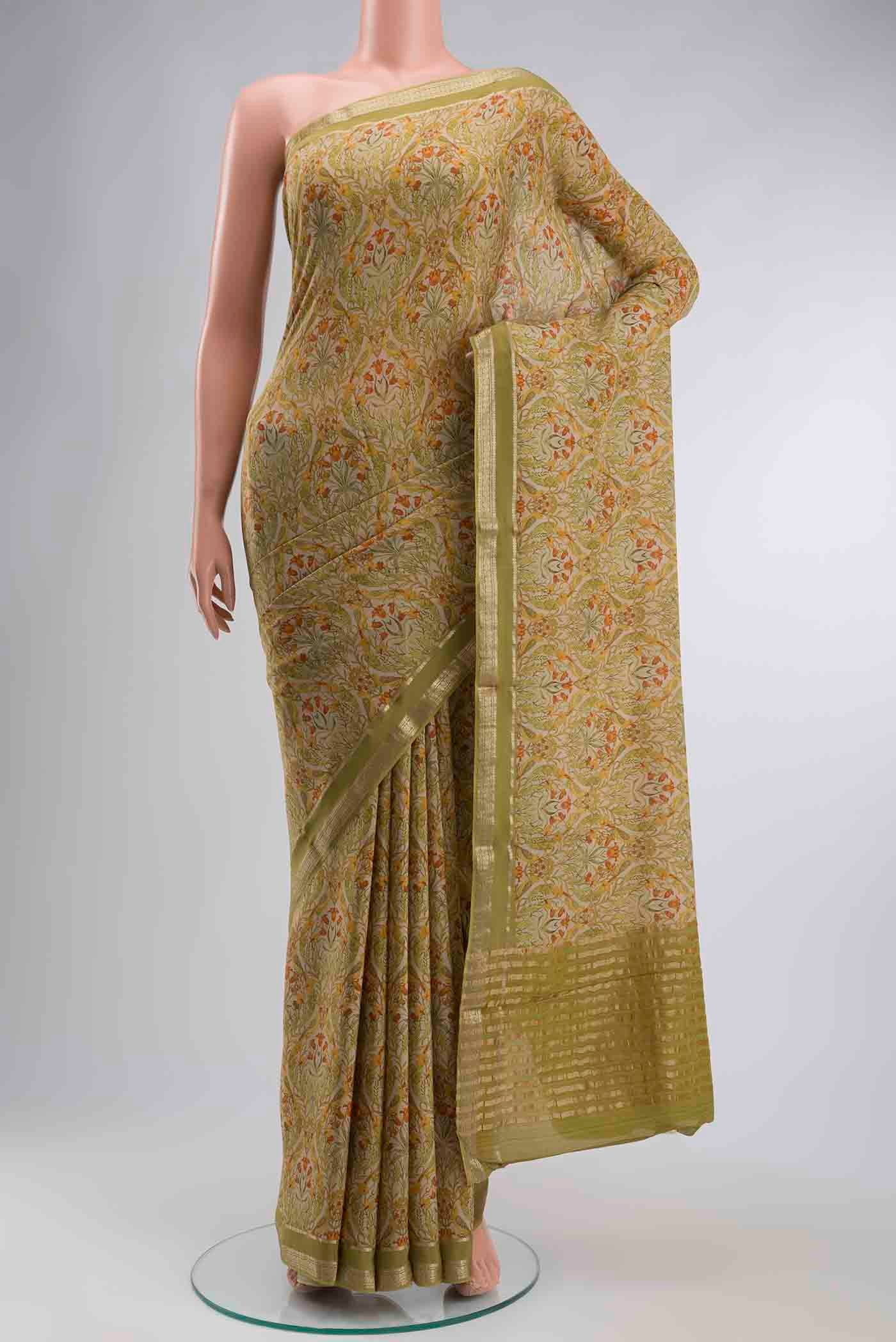 Green Mysore Crepe Saree with Printed design on the body and Zari Border displayed on a mannequin
