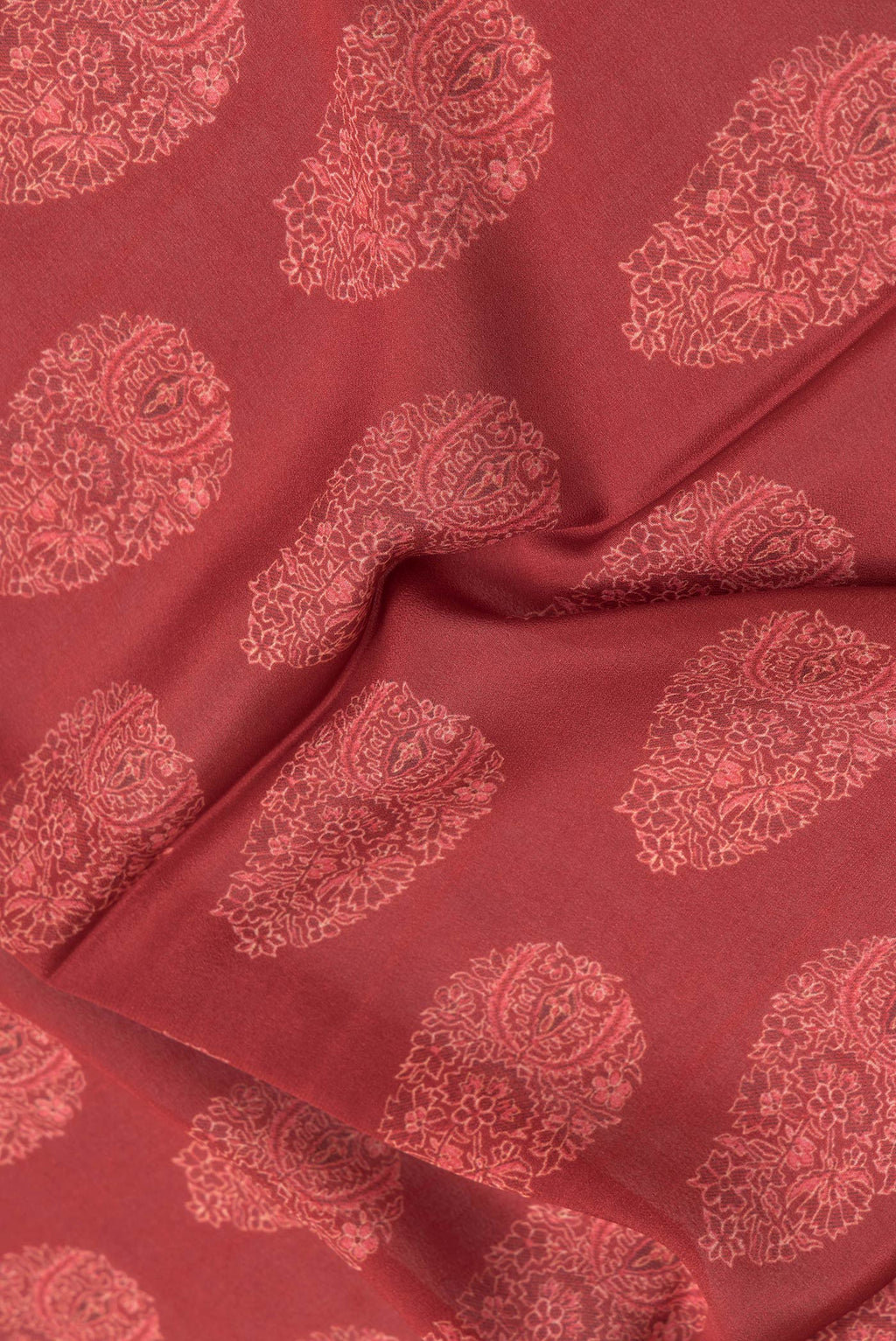 Close up of Maroon Dual Tone Crepe Saree with Printed design on the body and Zari Border.  displaying folds
