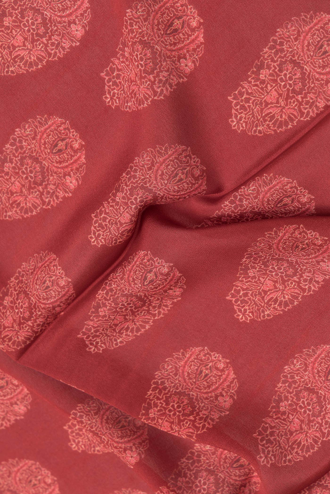 Close up of Maroon Dual Tone Crepe Saree with Printed design on the body and Zari Border.  displaying folds