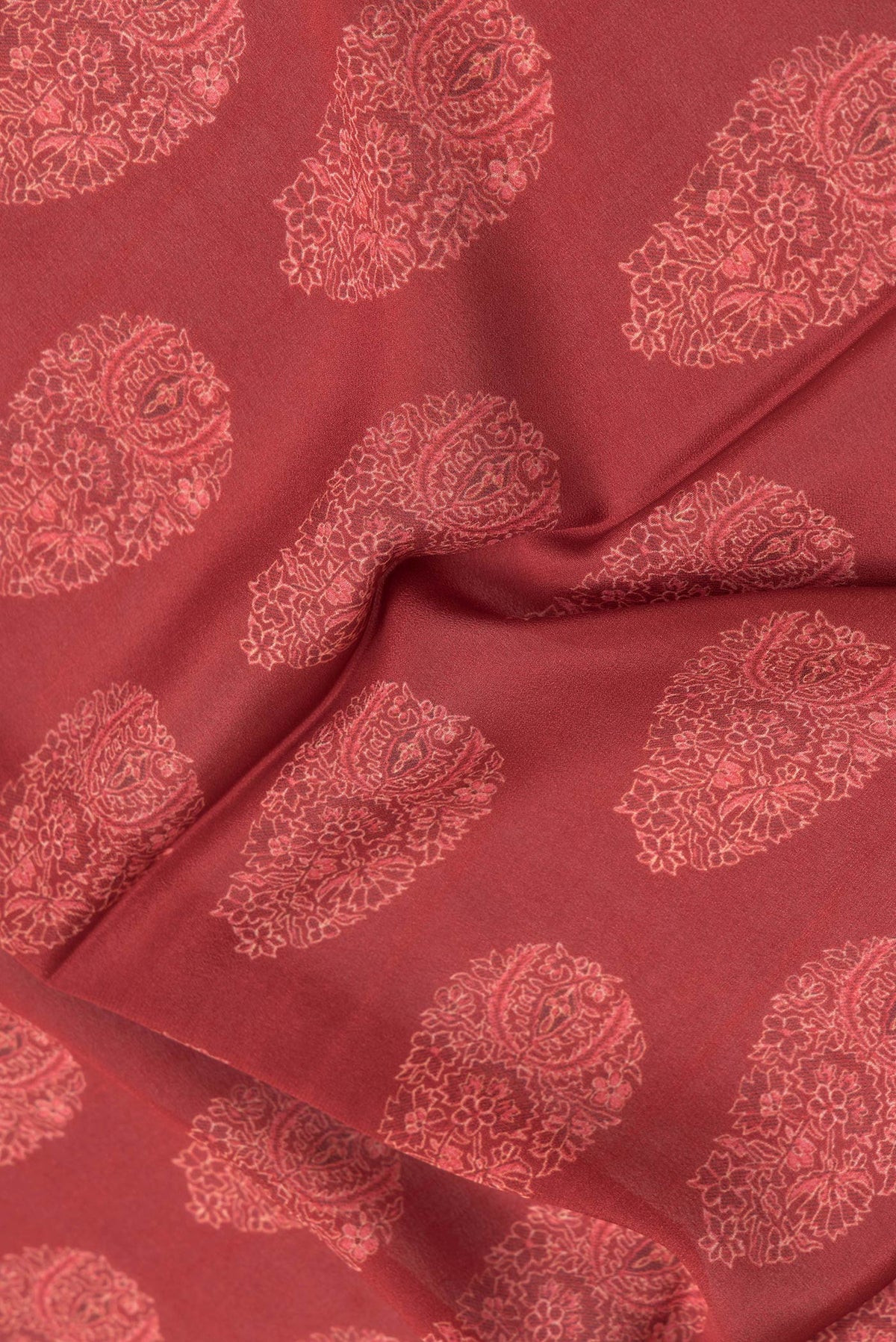 Close up of Maroon Dual Tone Crepe Saree with Printed design on the body and Zari Border.  displaying folds