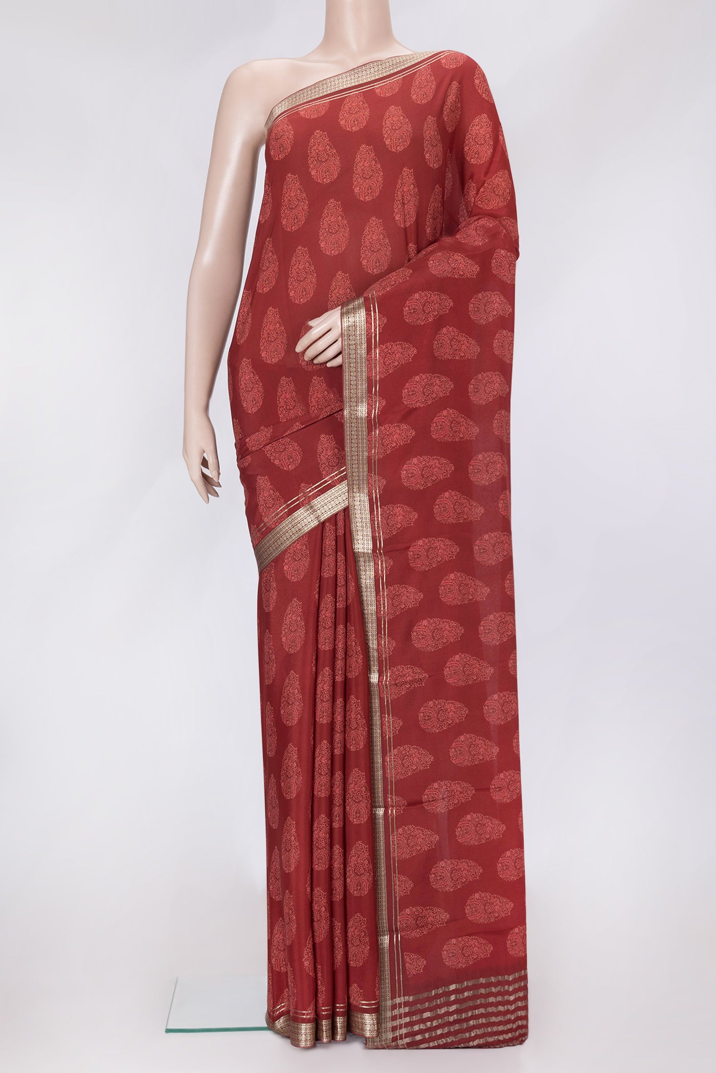 Maroon Dual Tone Crepe Saree with Printed design on the body and Zari Border.  displayed on a mannequin