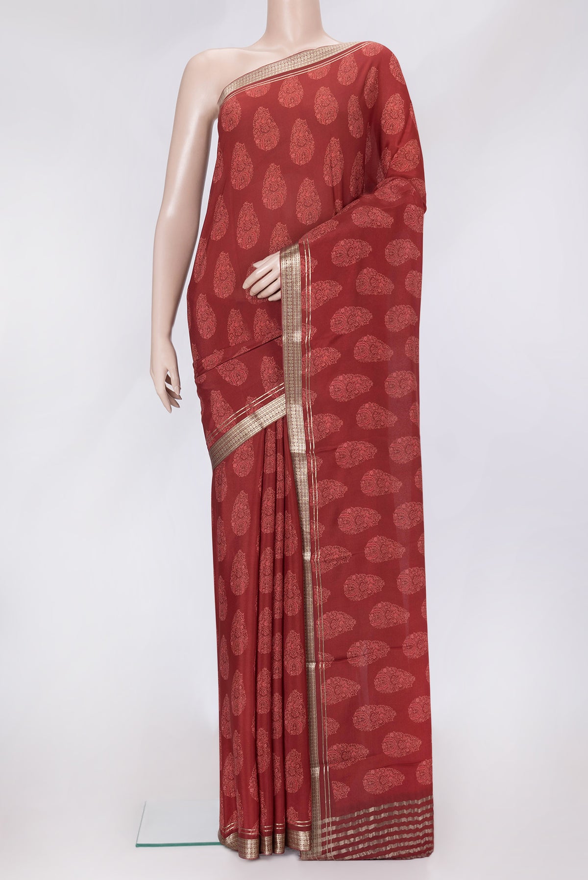Maroon Dual Tone Crepe Saree with Printed design on the body and Zari Border.  displayed on a mannequin