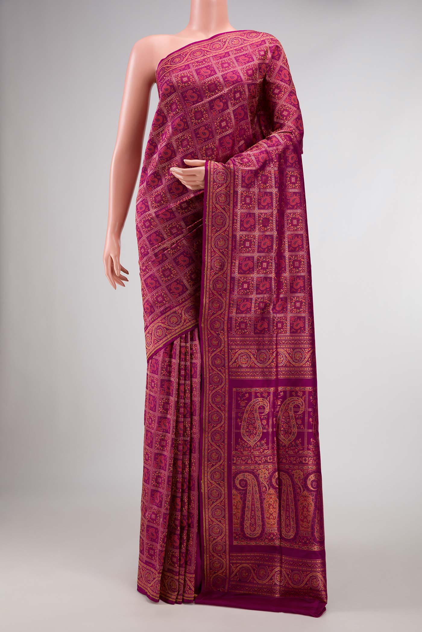 Magenta Banarasi Silk Saree with Checked design on the body and Zari Border displayed on a mannequin