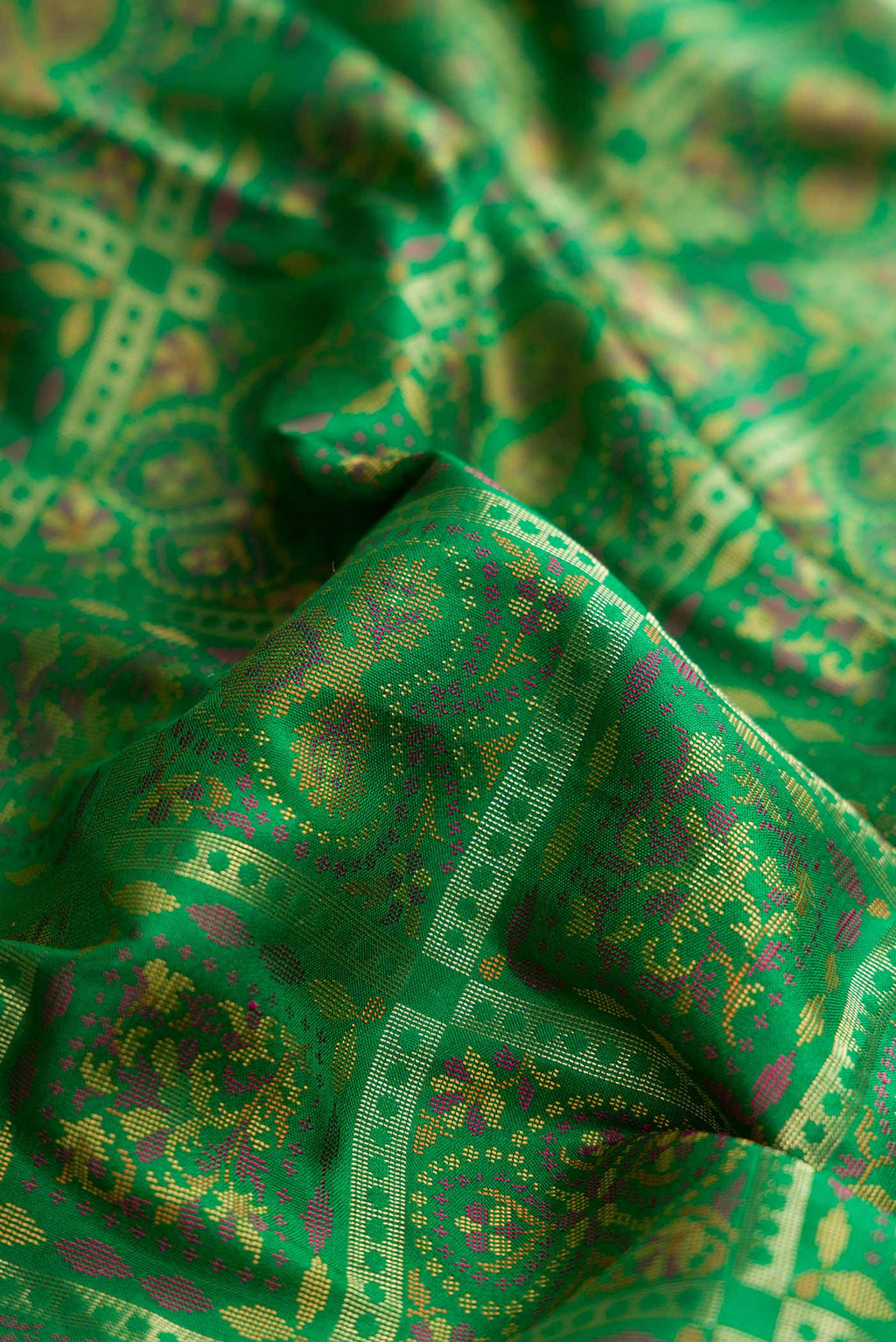 Close up of Green Dual Tone Banarasi Silk Saree with Zari Brocade on the body and Zari Border displaying folds