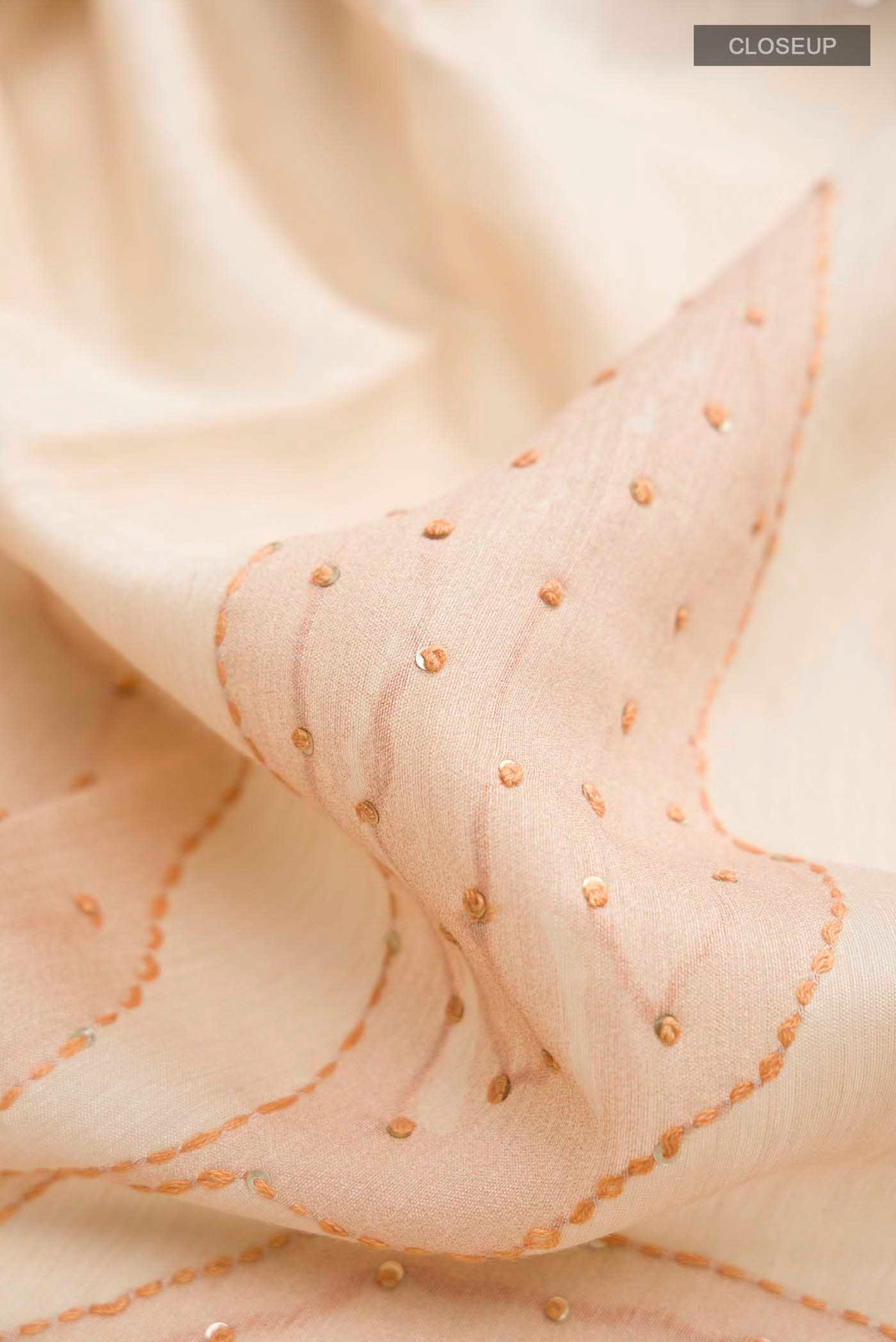 Close up of Brown Bhagalpuri Tussar Silk Saree with Embroidery on the body and Zari Border displaying folds